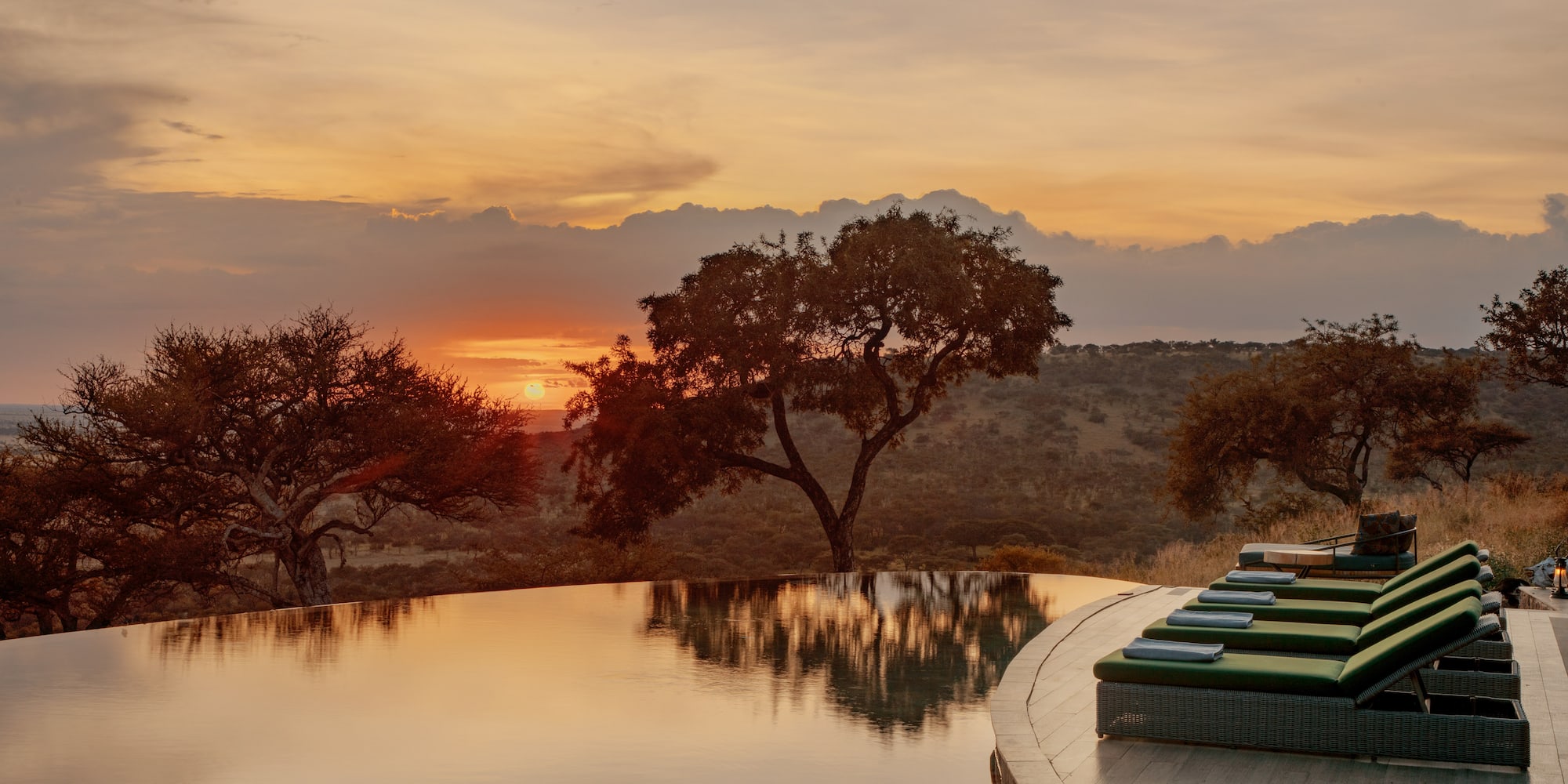 a pool with a view of the sunset