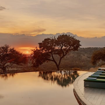 a pool with a view of the sunset