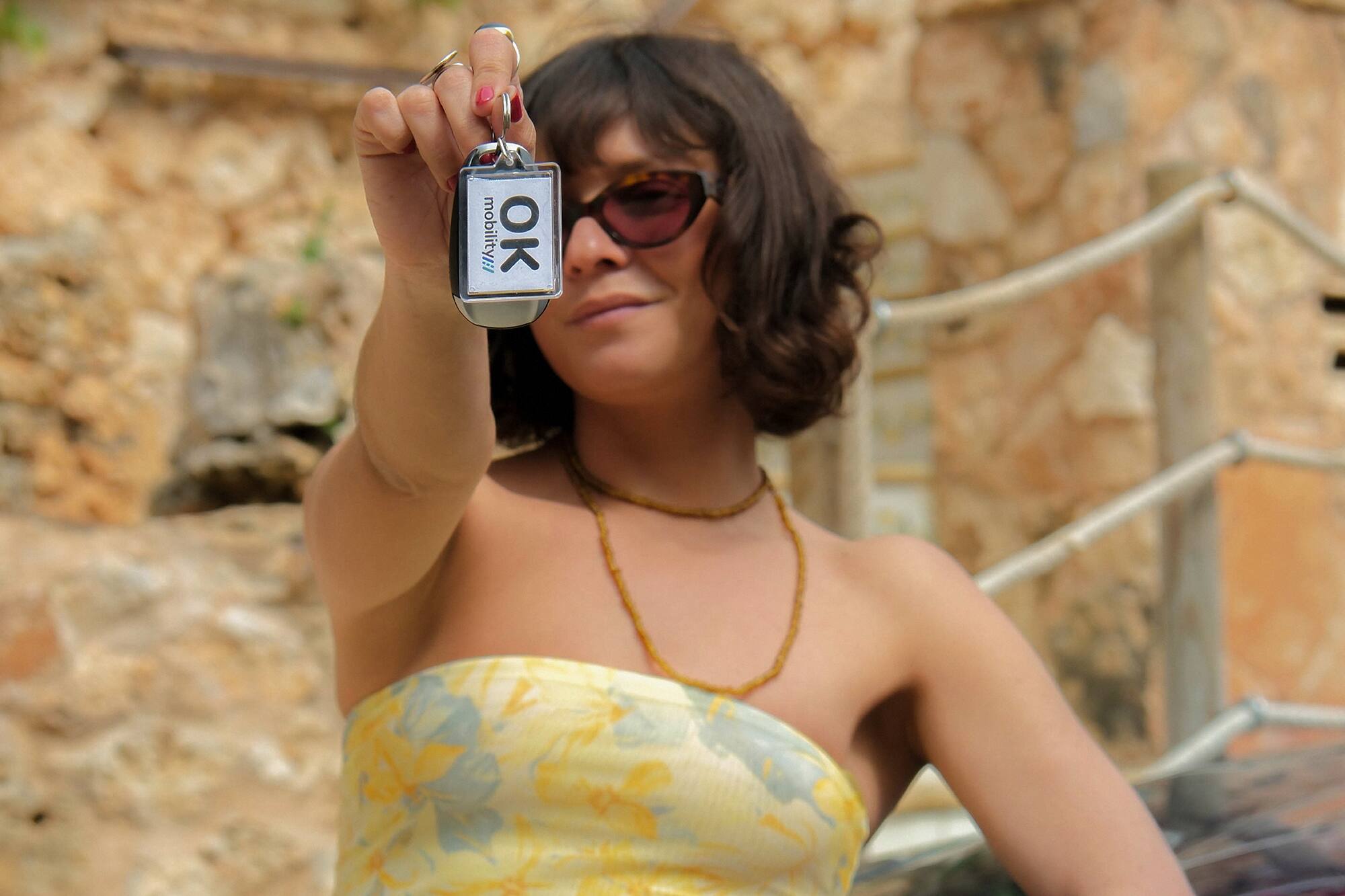 a woman holding up a keychain