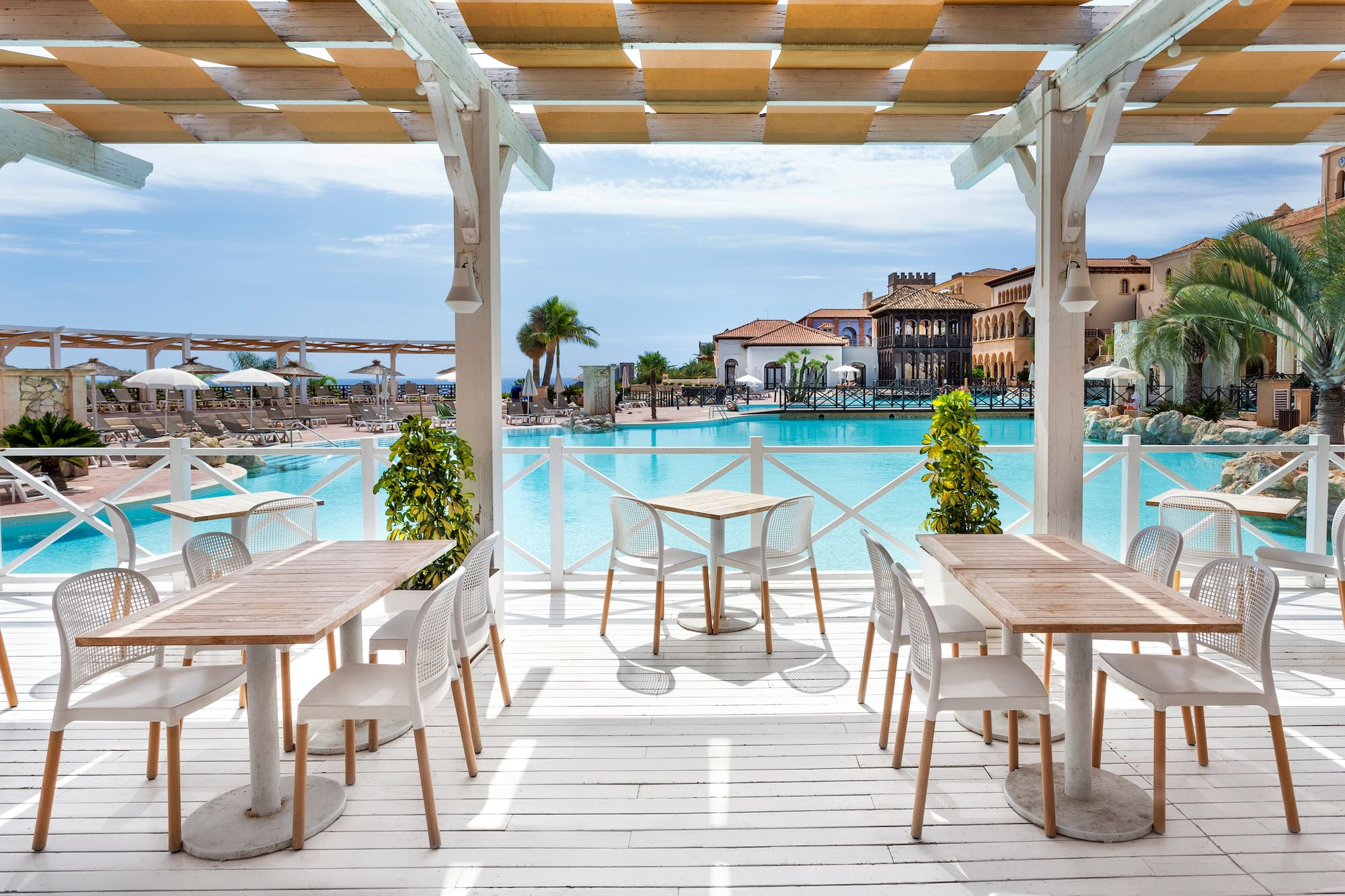 a pool with tables and chairs