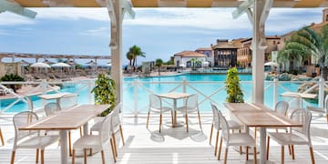 a pool with tables and chairs