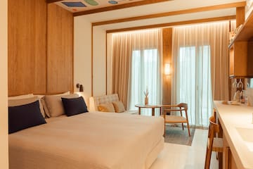 a bedroom with a bed and a chair