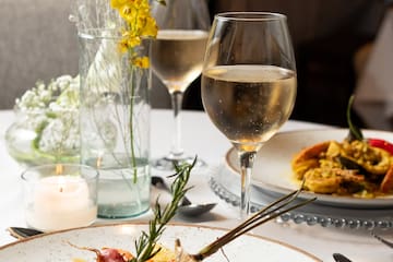 a plate of food and wine glasses on a table