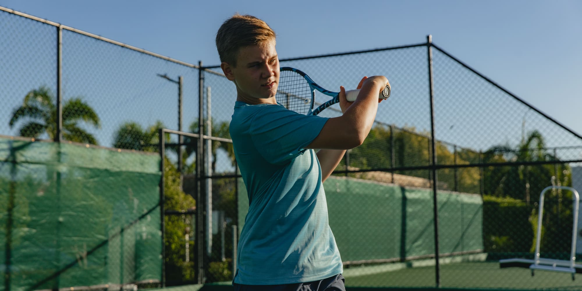 a boy holding a tennis racket
