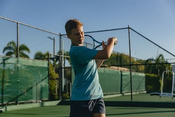 a boy holding a tennis racket
