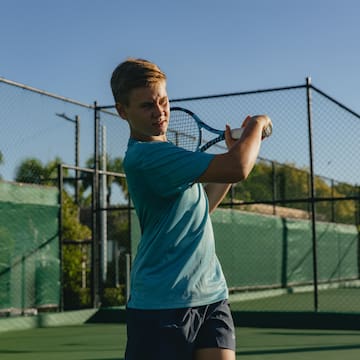 a boy holding a tennis racket
