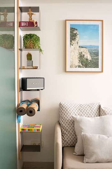 a room with a couch and a picture on the wall