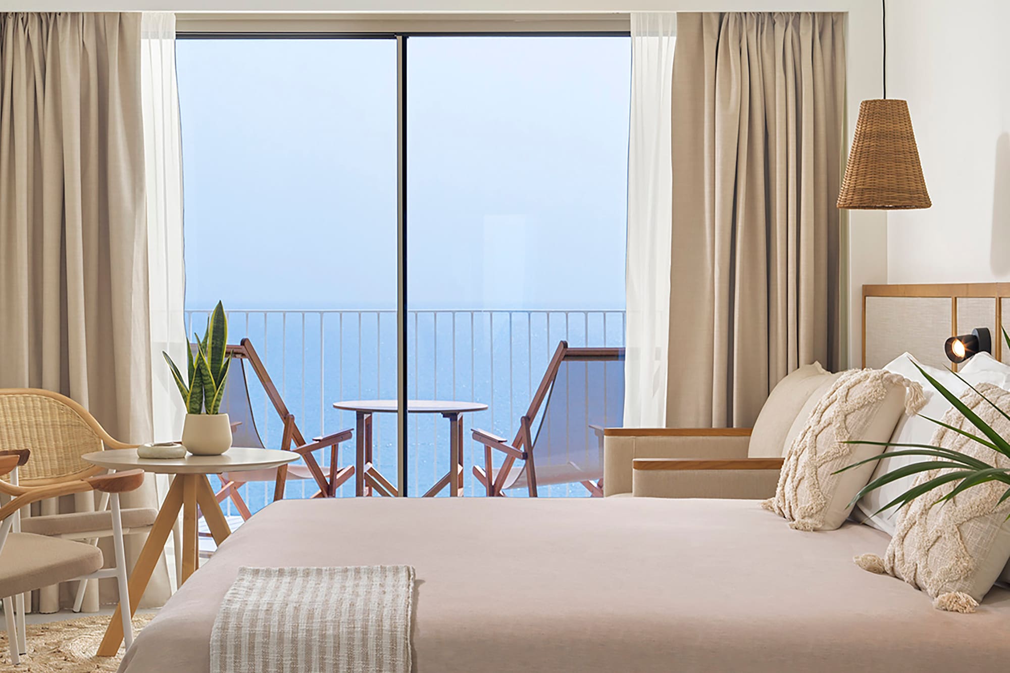 a bedroom with a large bed and a ceiling fan