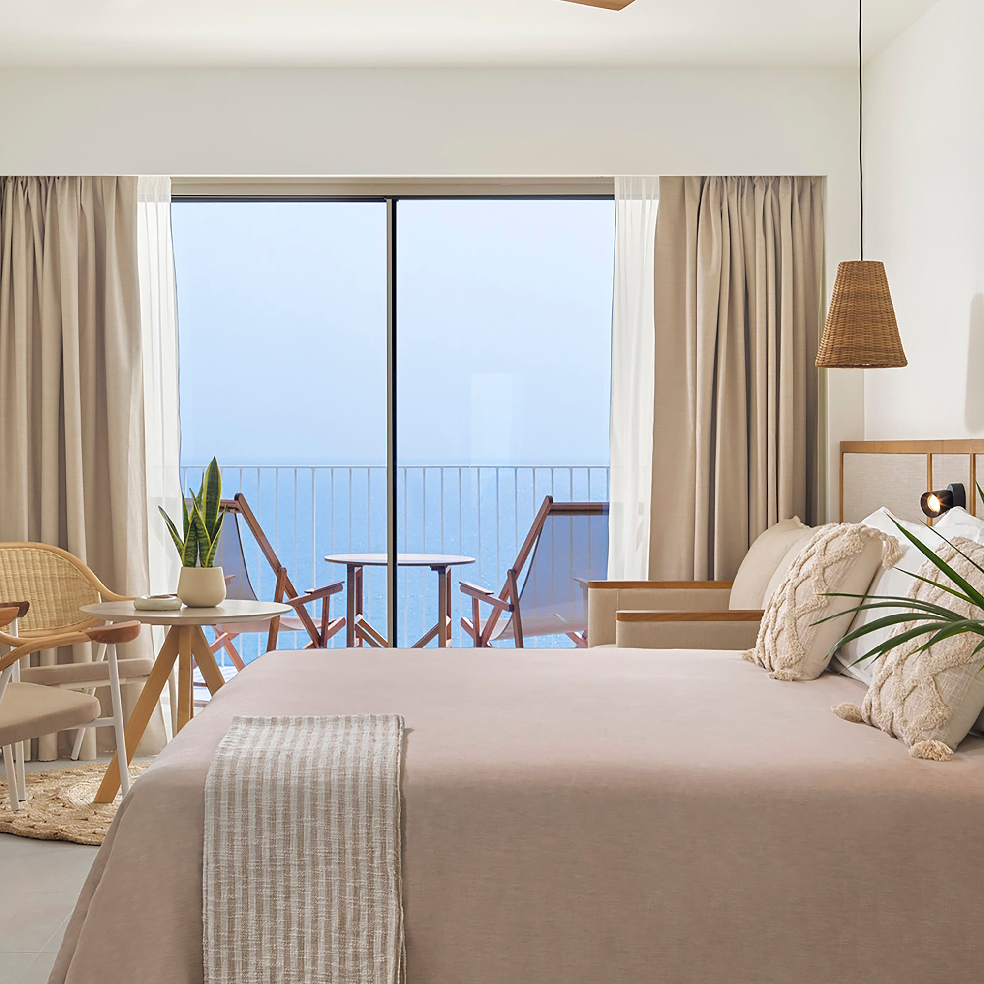 a bedroom with a large bed and a ceiling fan