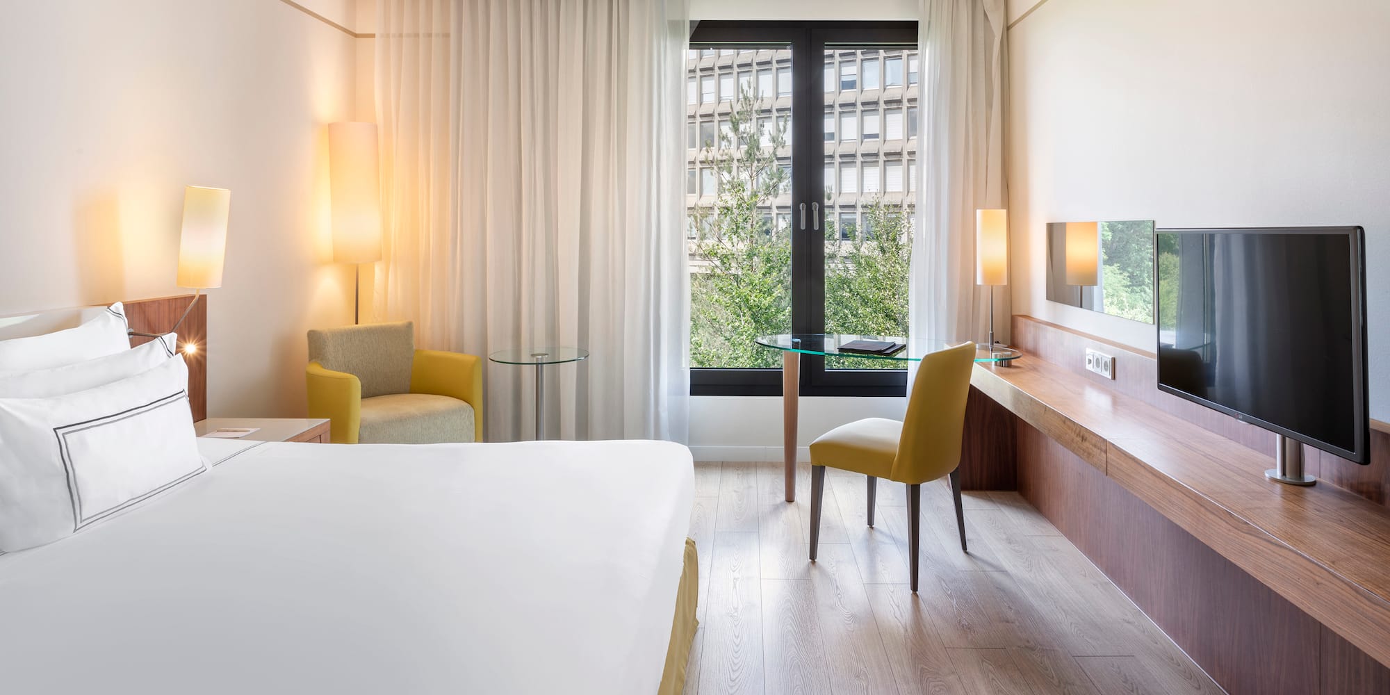 a room with a bed and a table and chairs