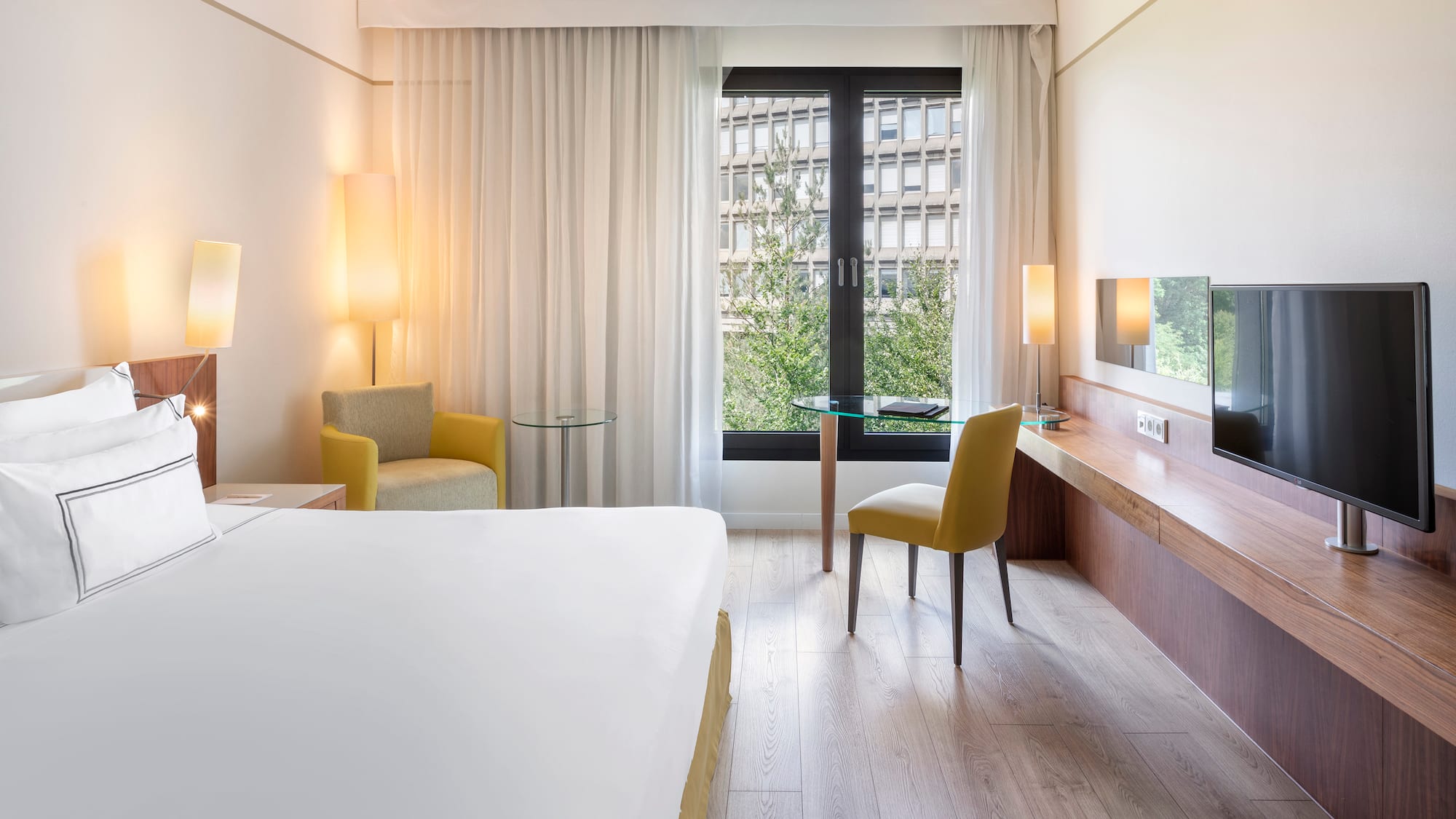 a room with a bed and a table and chairs