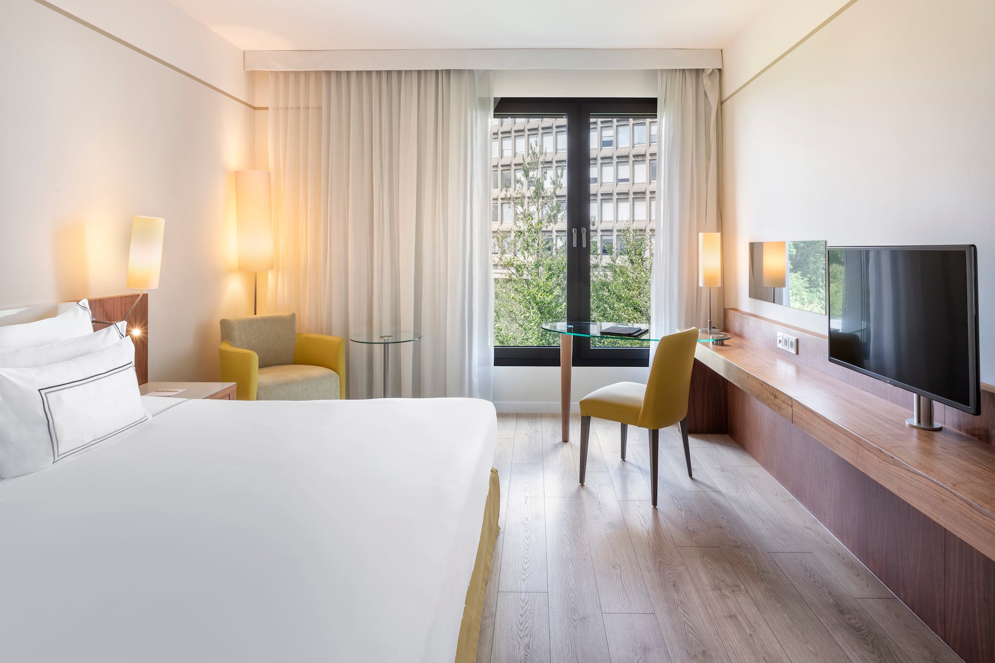 a room with a bed and a table and chairs