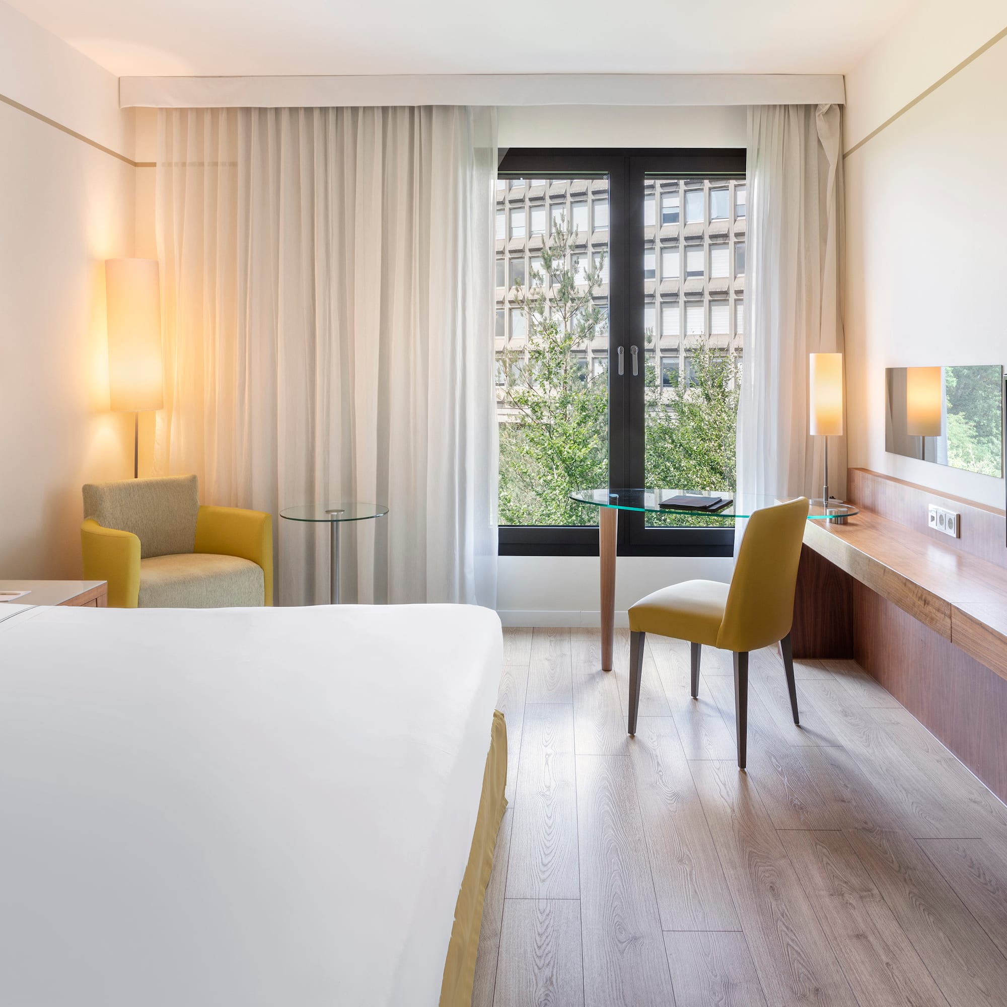 a room with a bed and a table and chairs