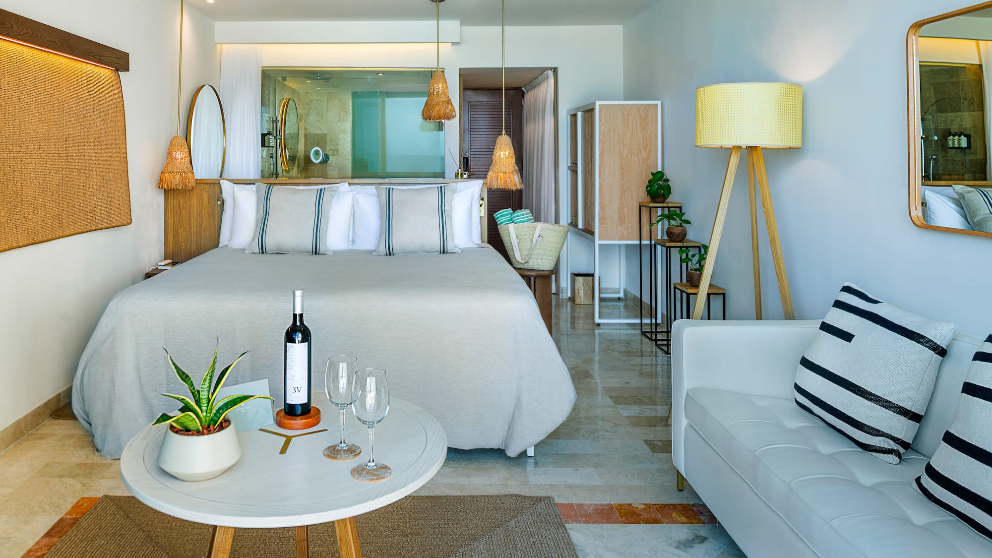 a room with a bed and a table and a wine bottle