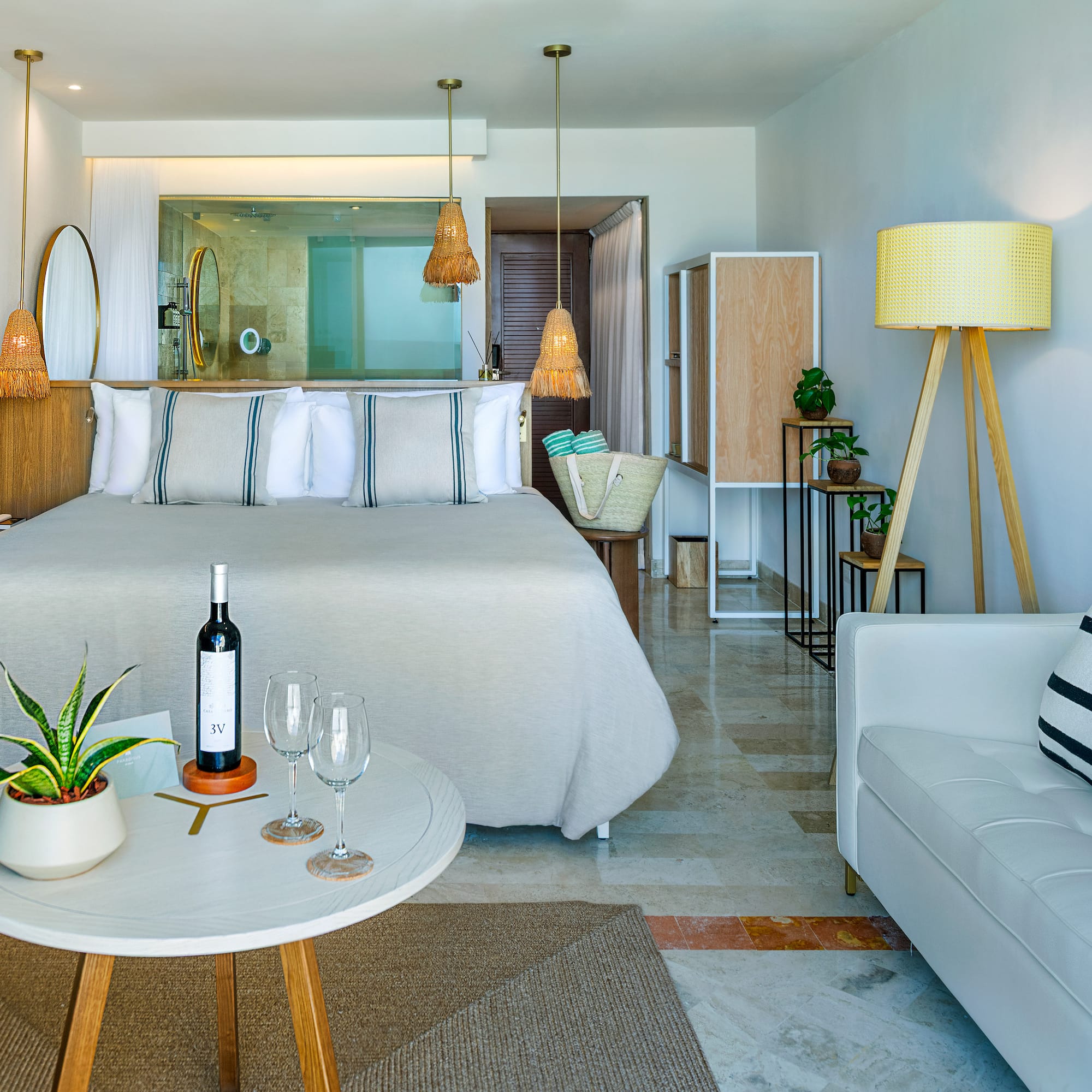 a room with a bed and a table and a wine bottle