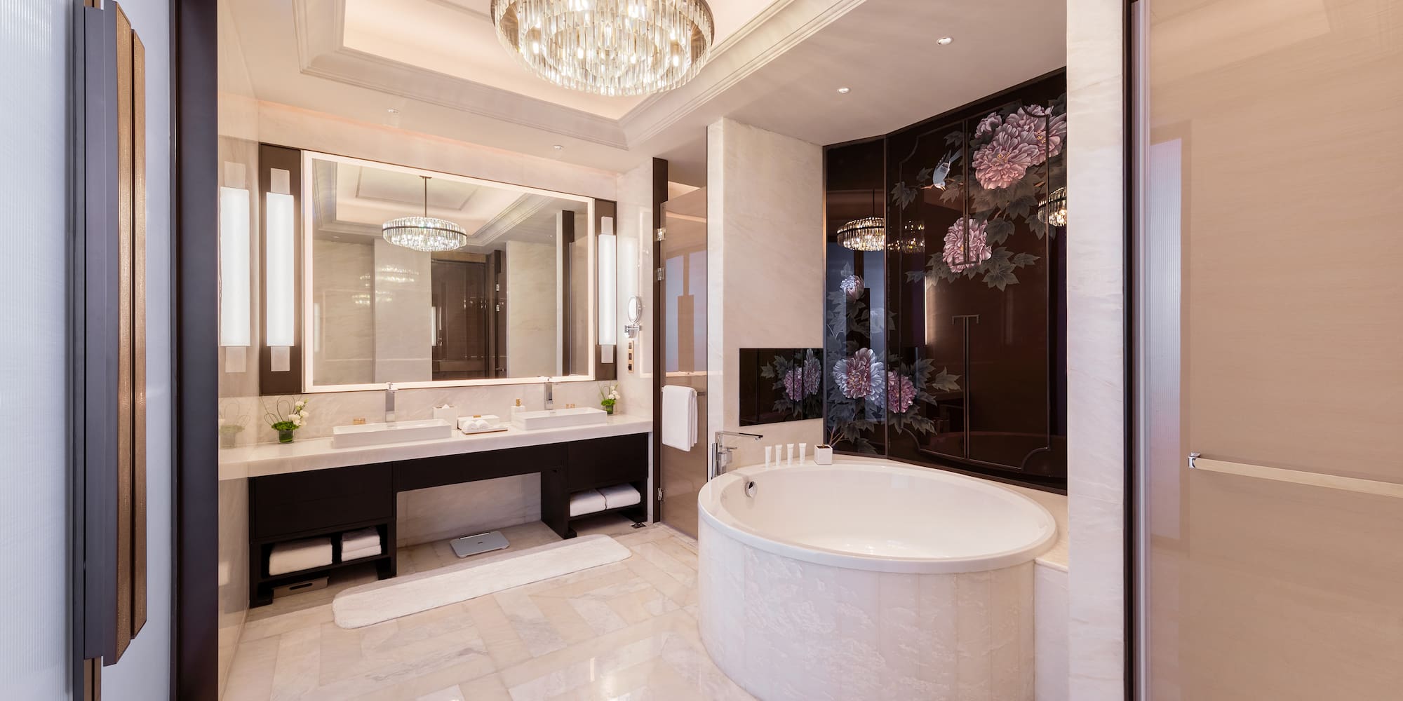 a bathroom with a large tub and a chandelier