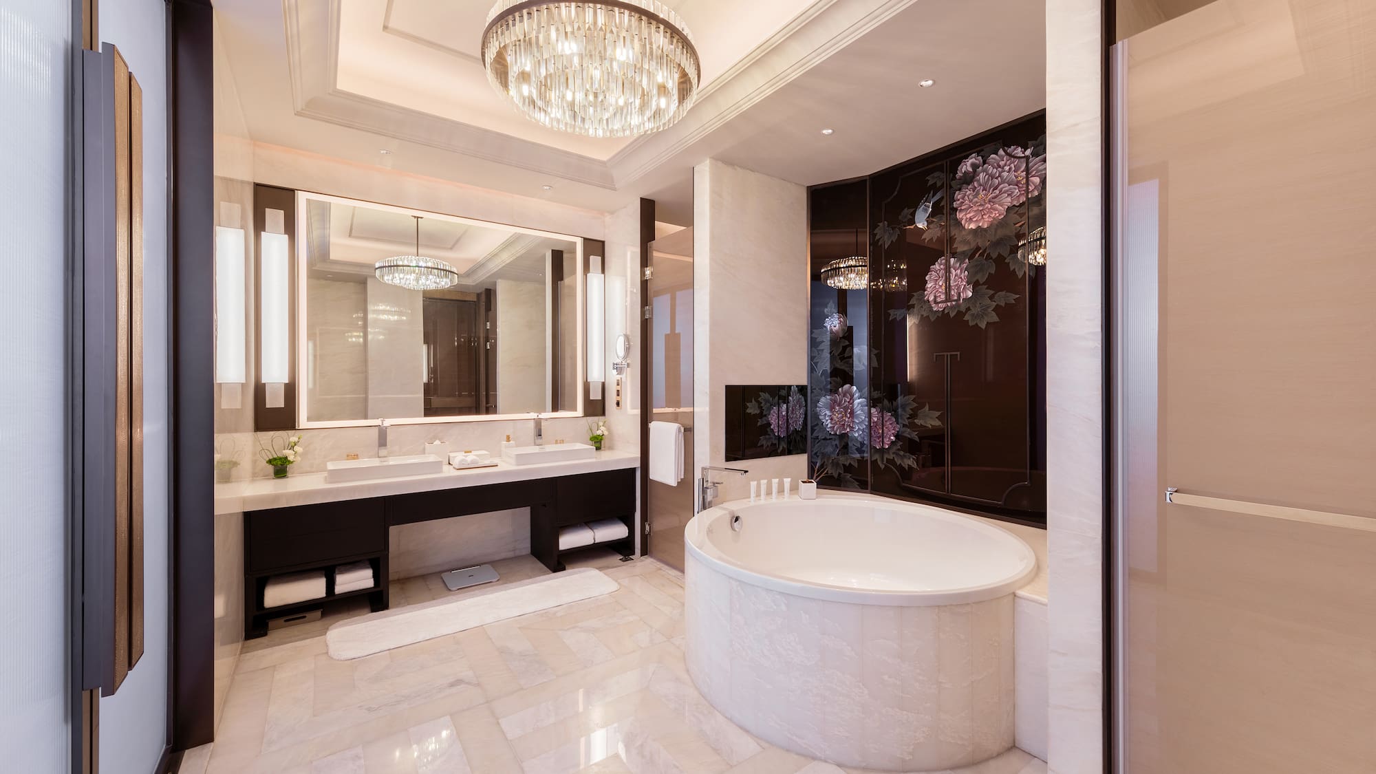 a bathroom with a large tub and a chandelier