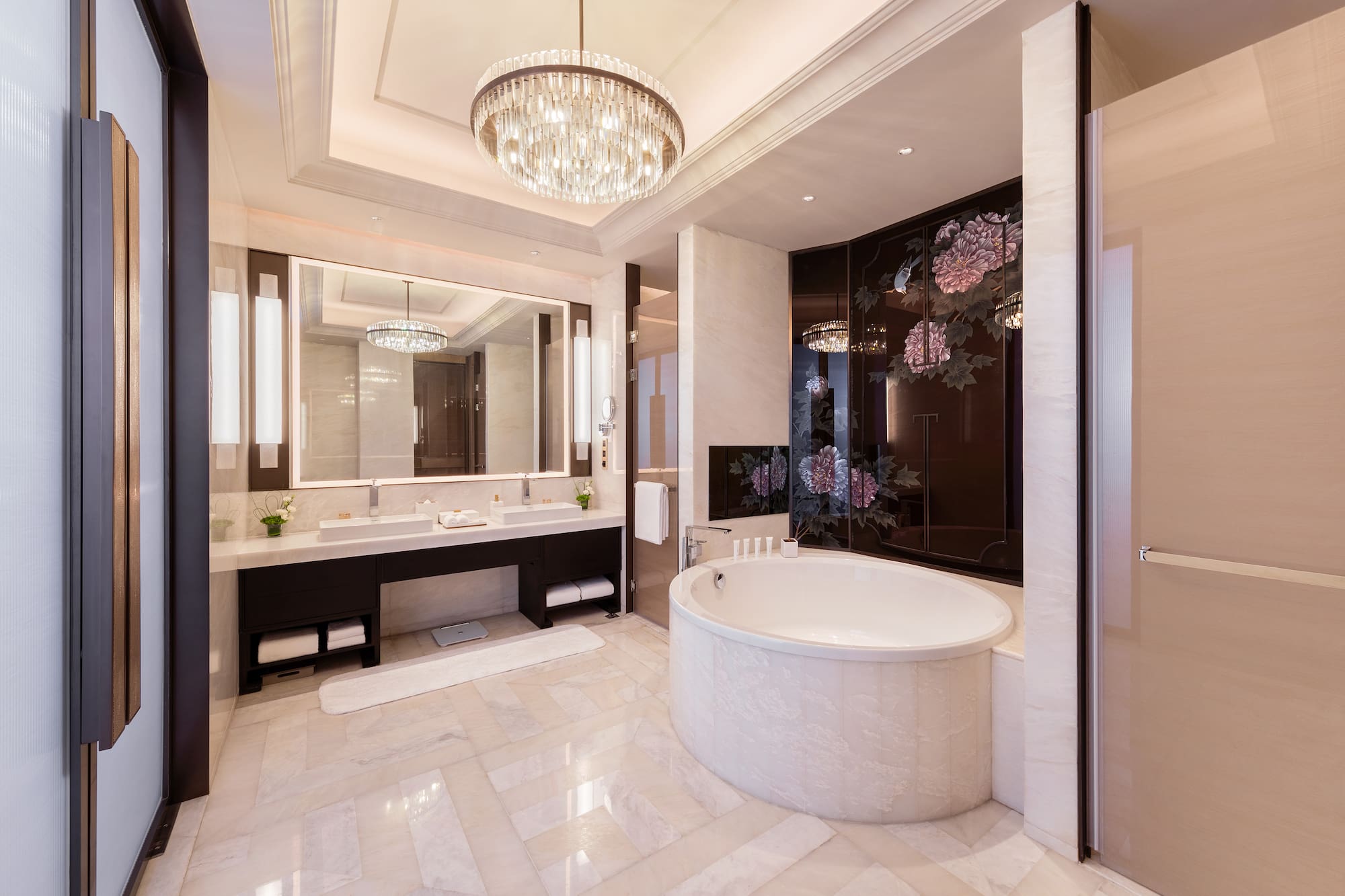 a bathroom with a large tub and a chandelier