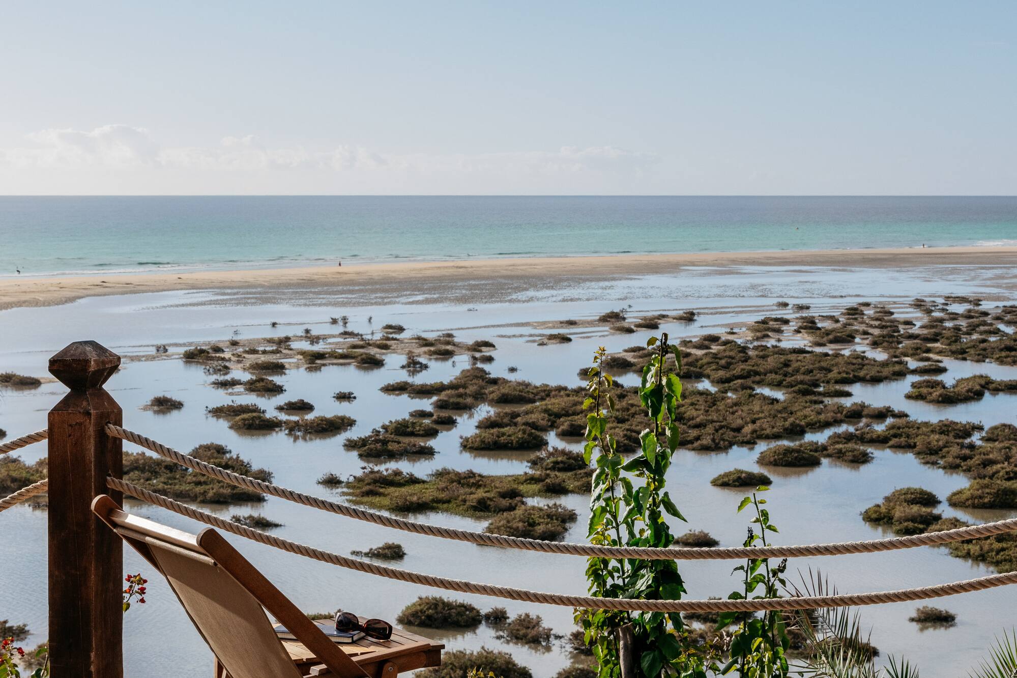 a chair on a deck overlooking a body of water