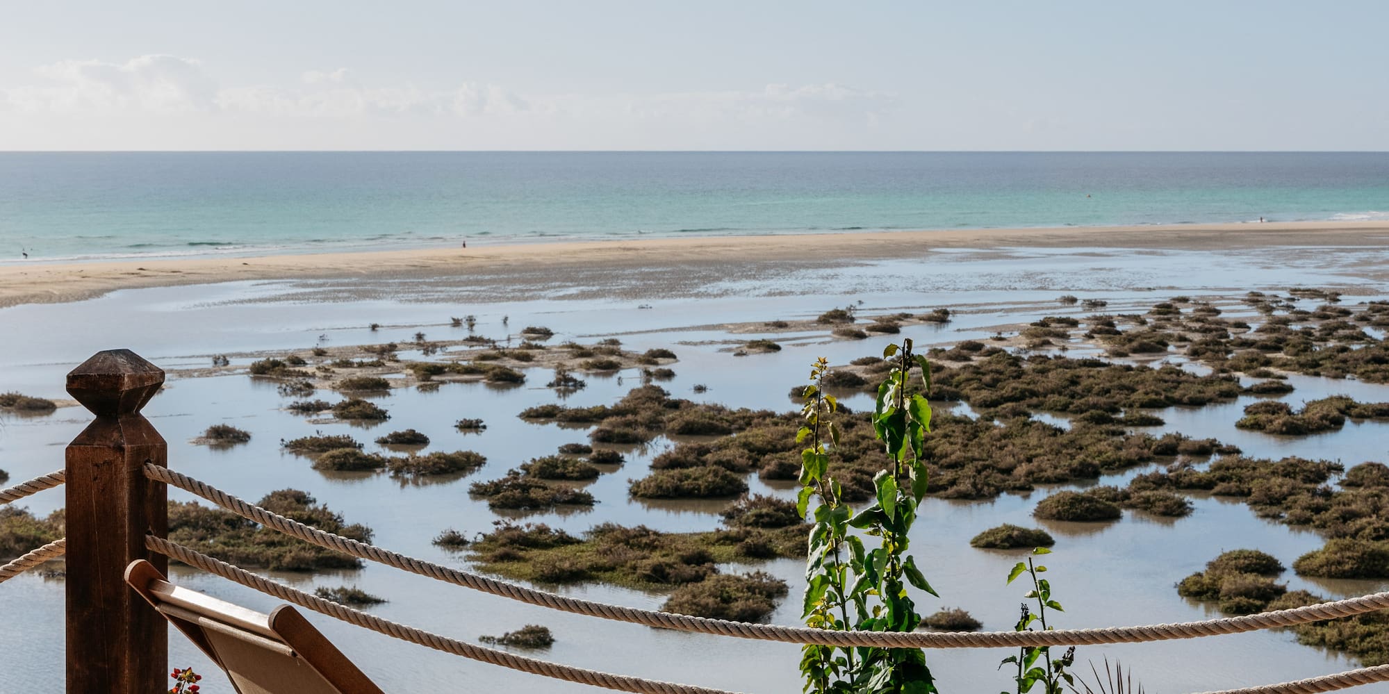 a chair on a deck overlooking a body of water