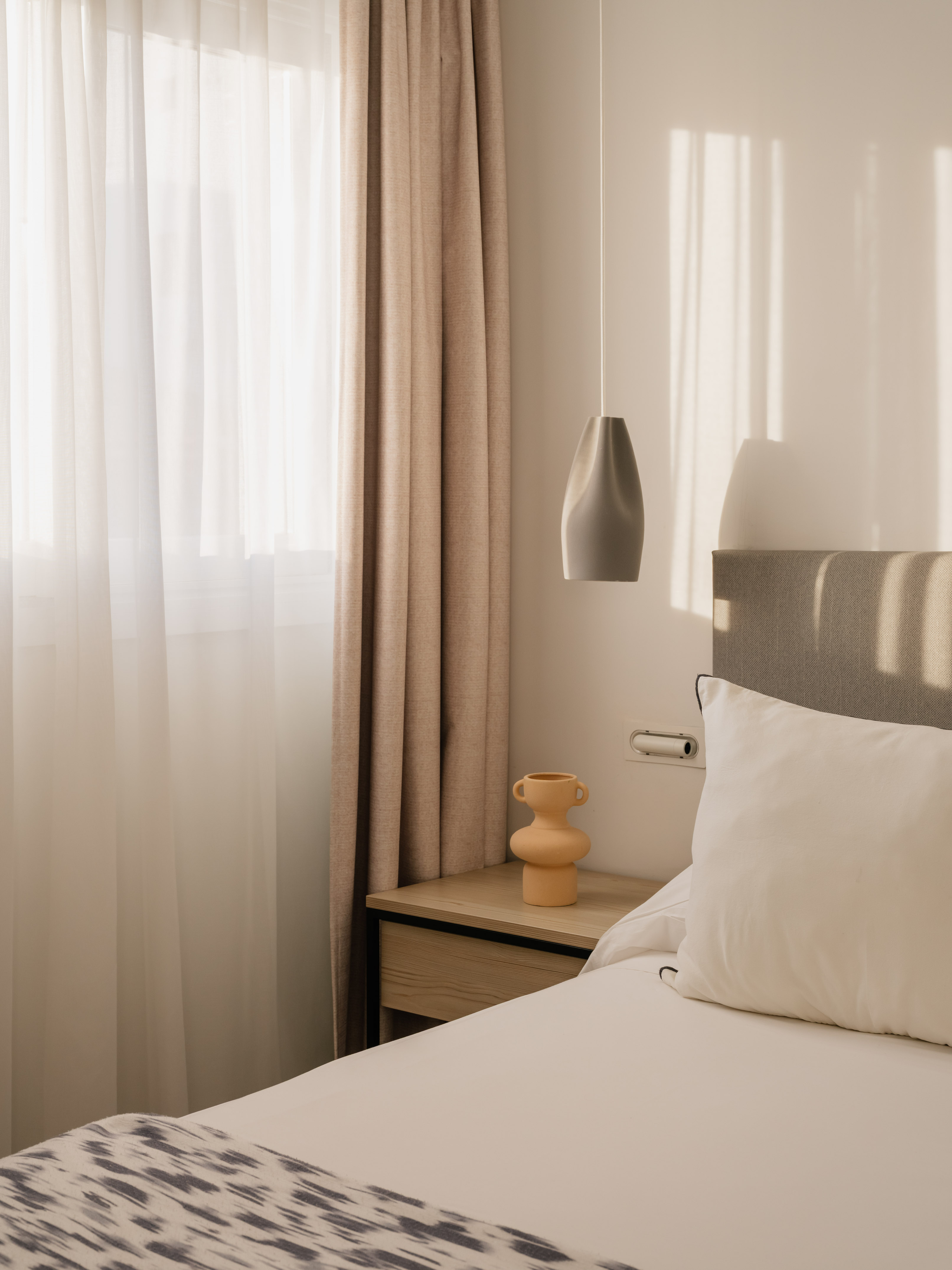 a bed with a lamp and a table