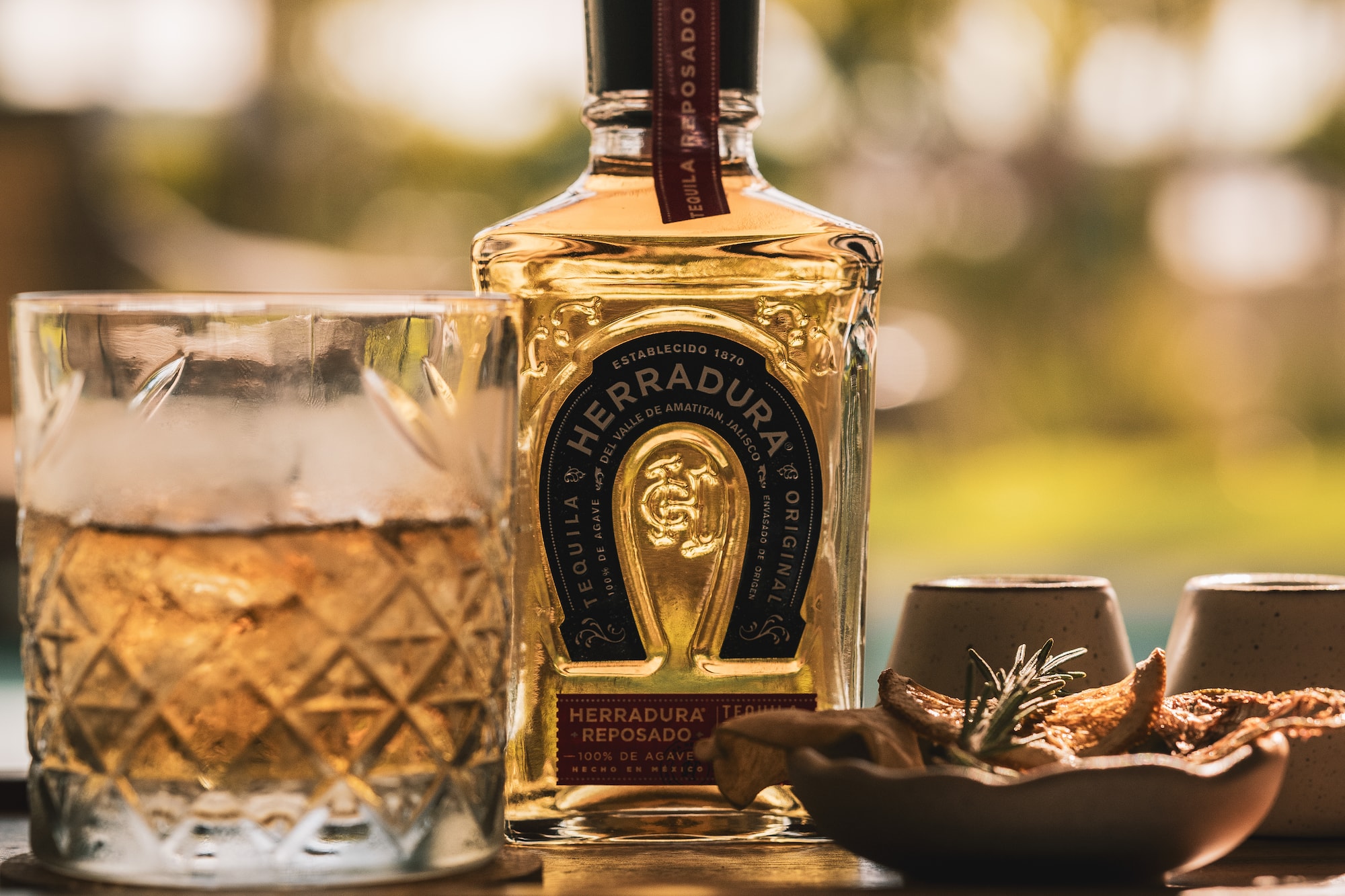 a bottle of alcohol next to a glass of liquid