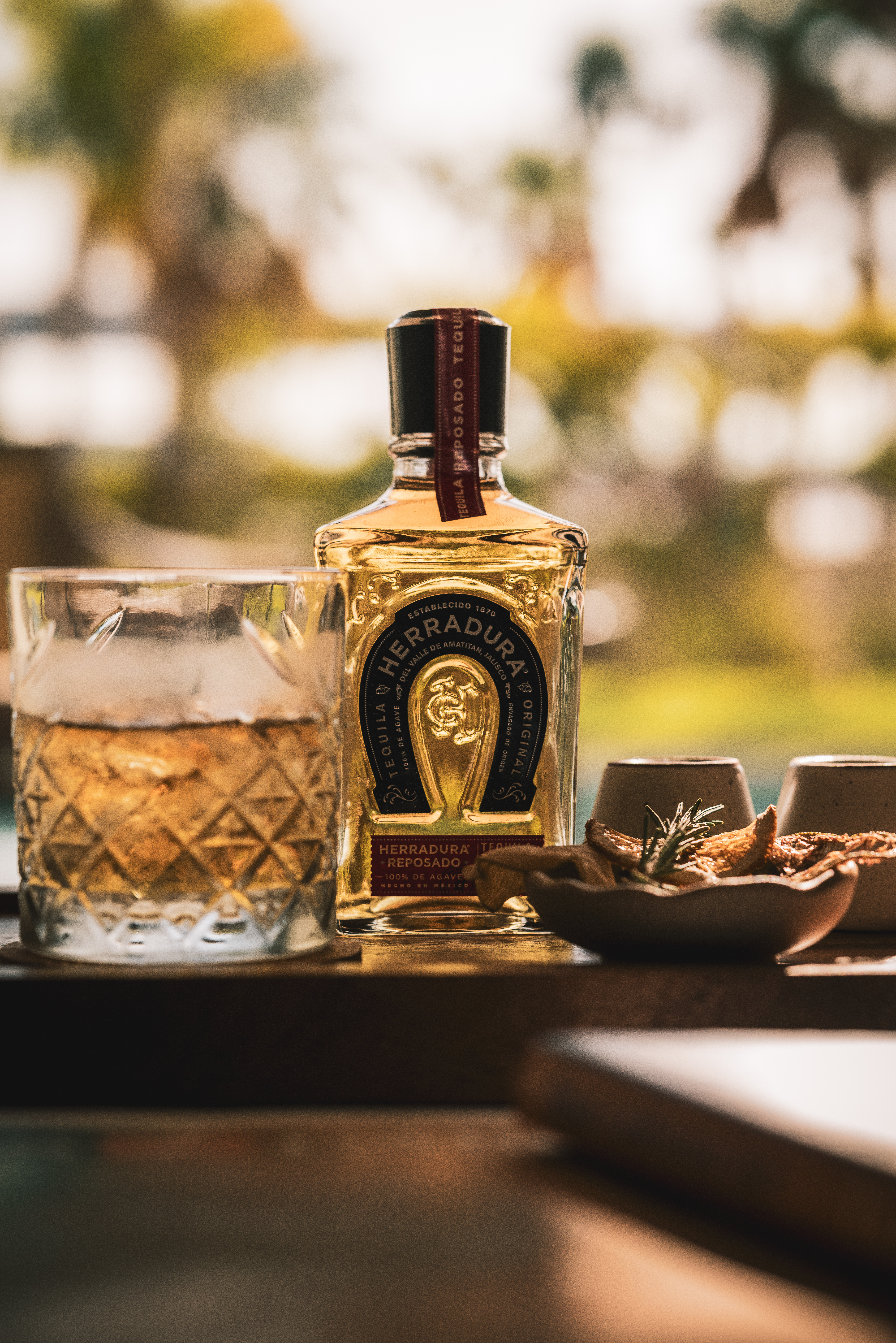 a bottle of alcohol next to a glass of liquid