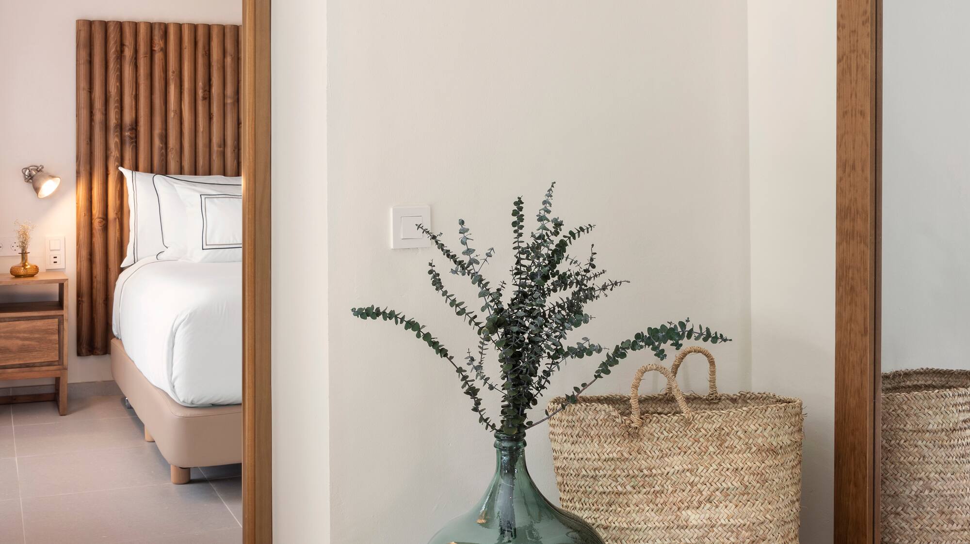 a vase with plants in it next to a basket