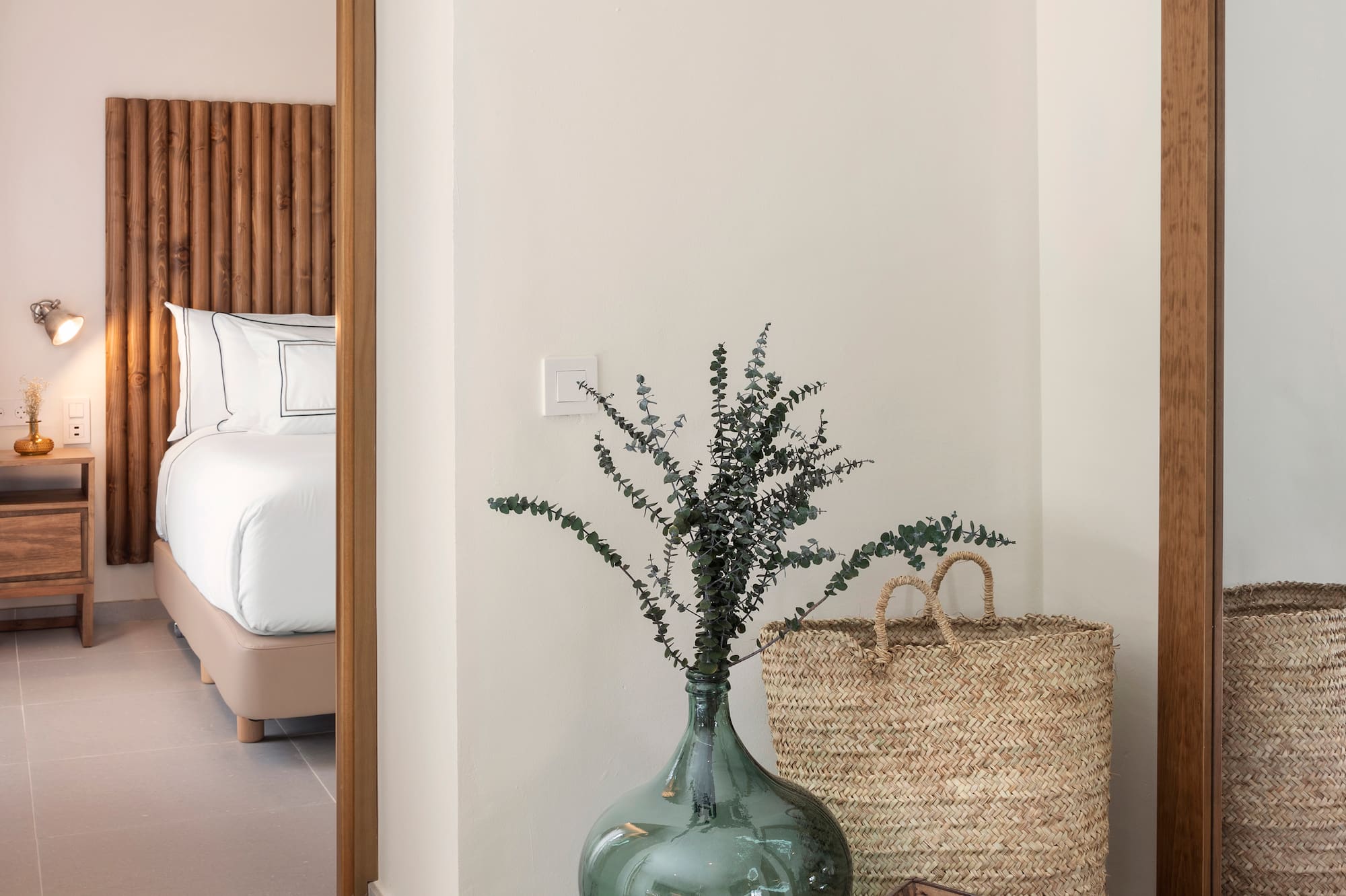 a vase with plants in it next to a basket