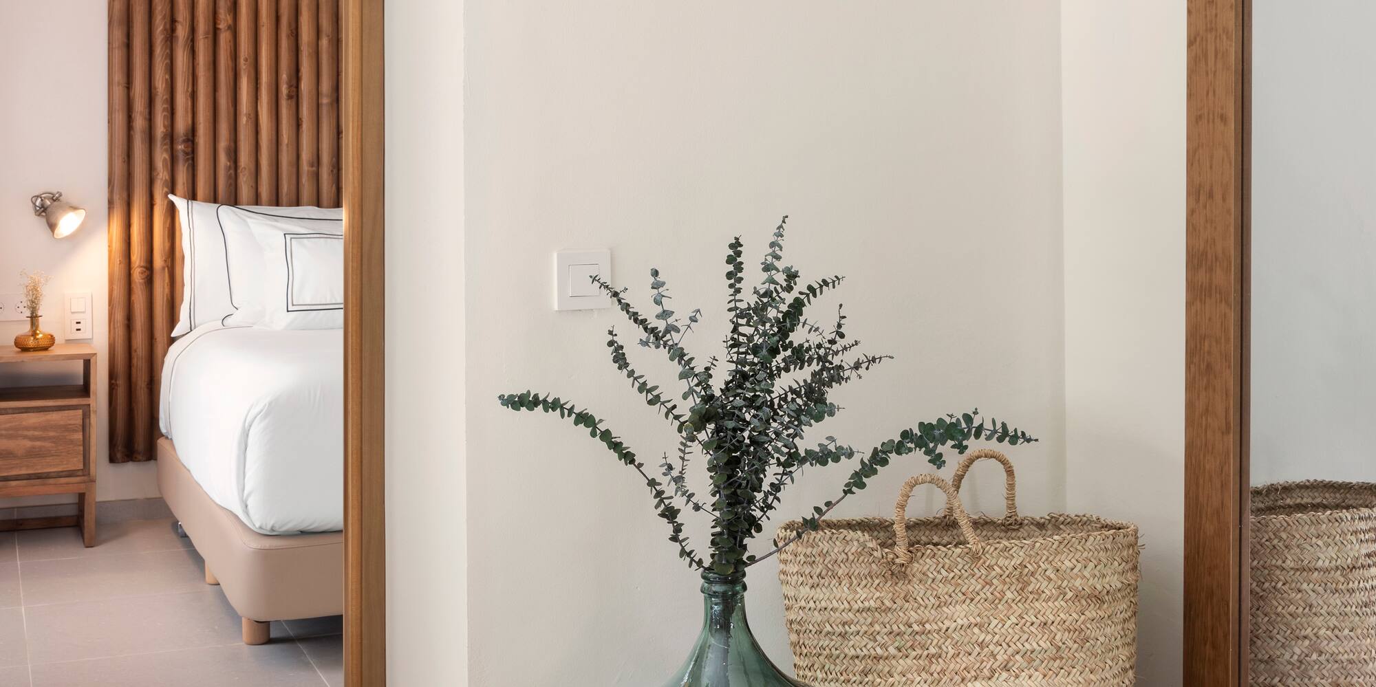 a vase with plants in it next to a basket