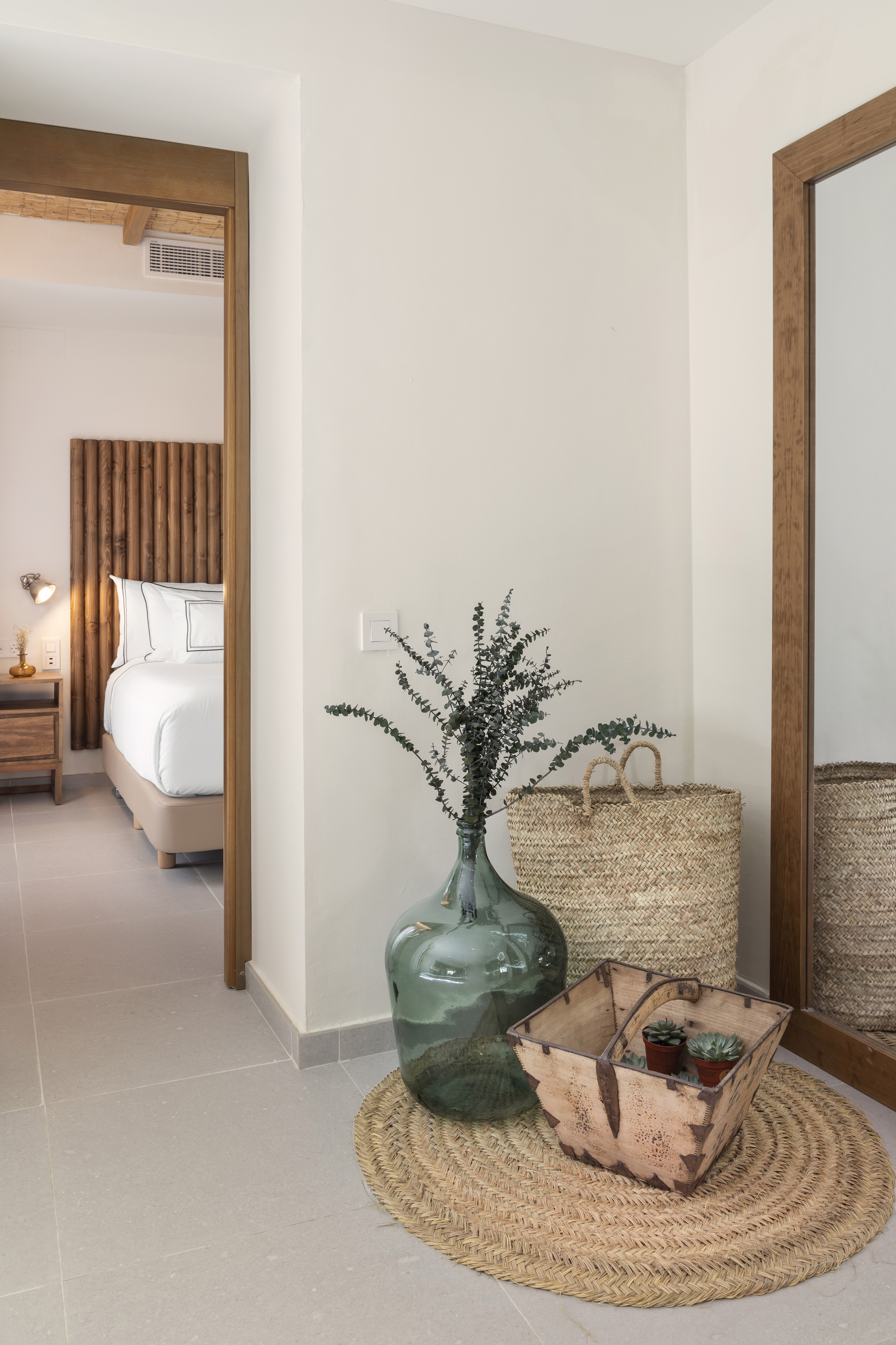 a vase with plants in it next to a basket