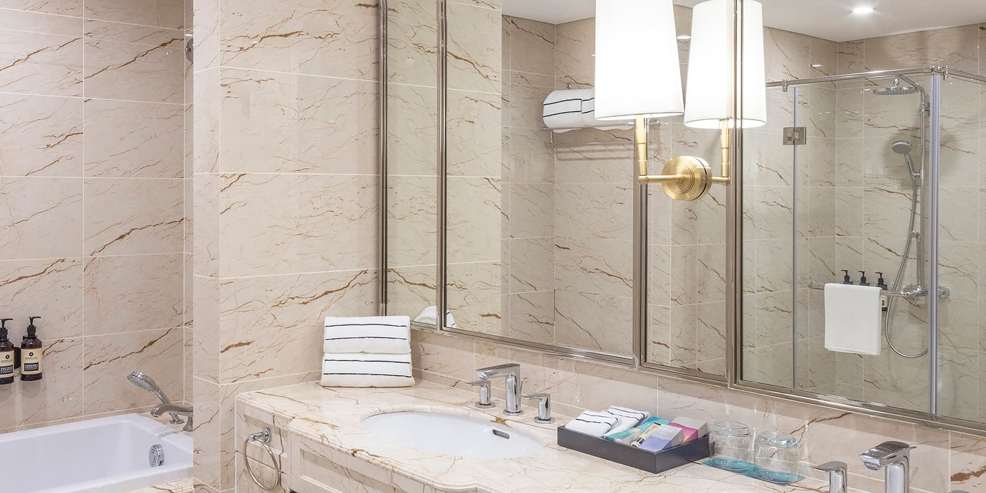 a bathroom with marble countertops and a tub