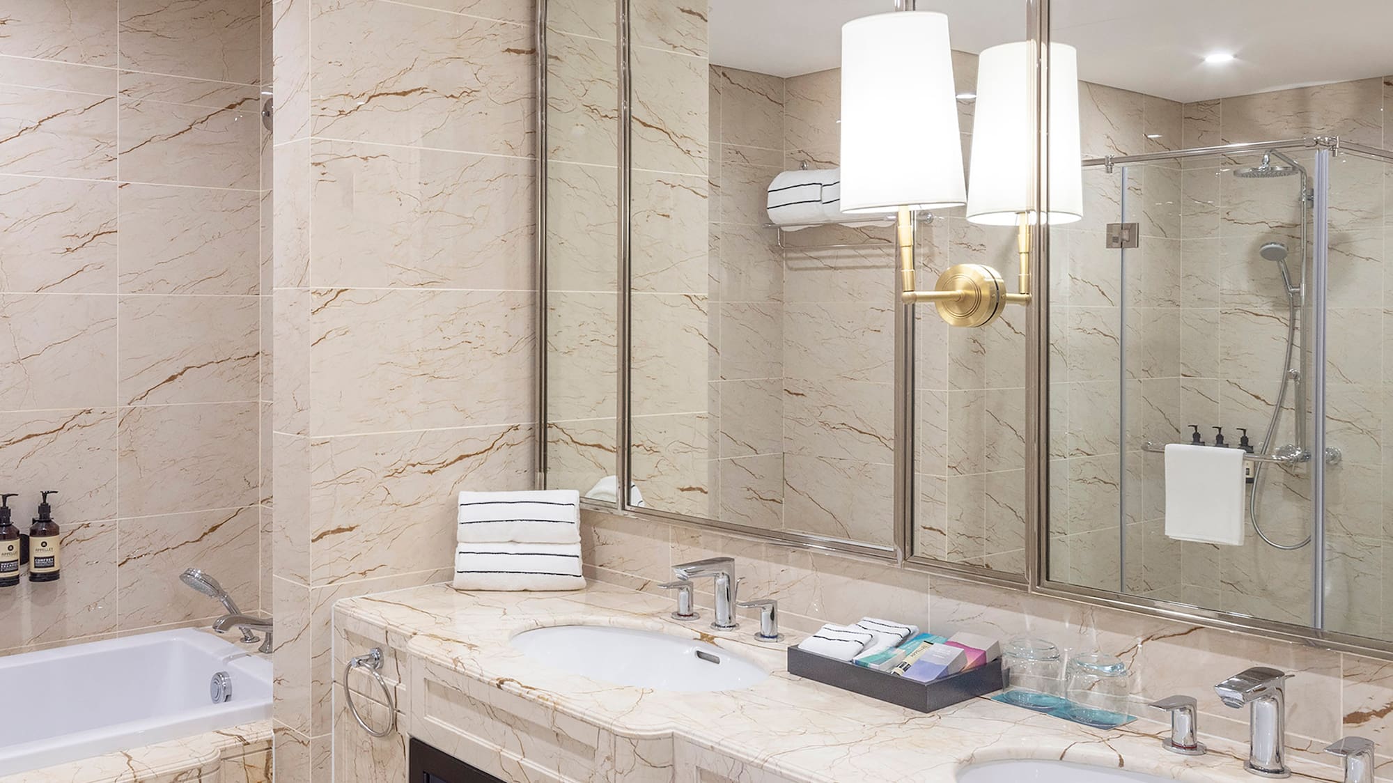 a bathroom with marble countertops and a tub