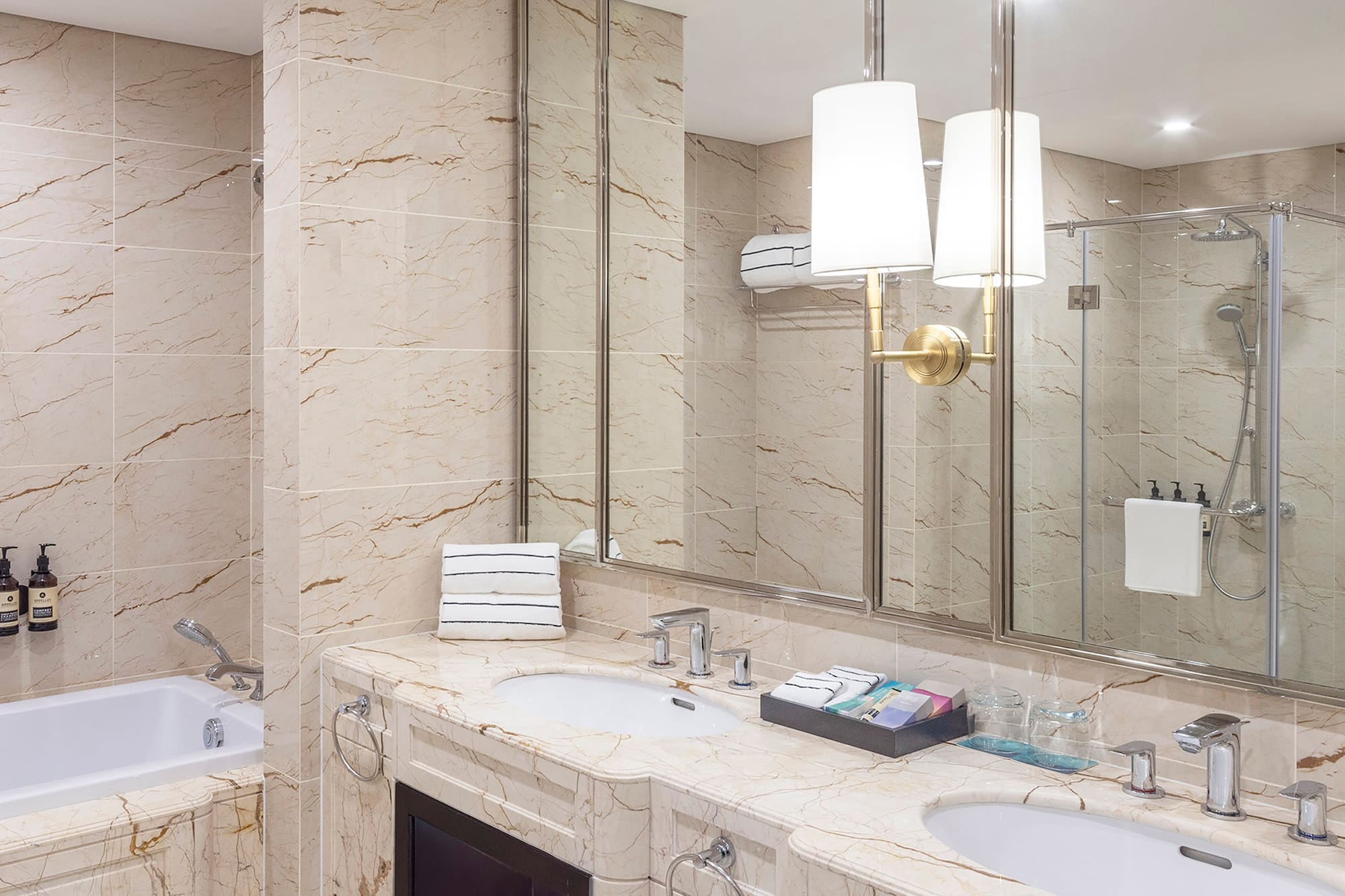 a bathroom with marble countertops and a tub