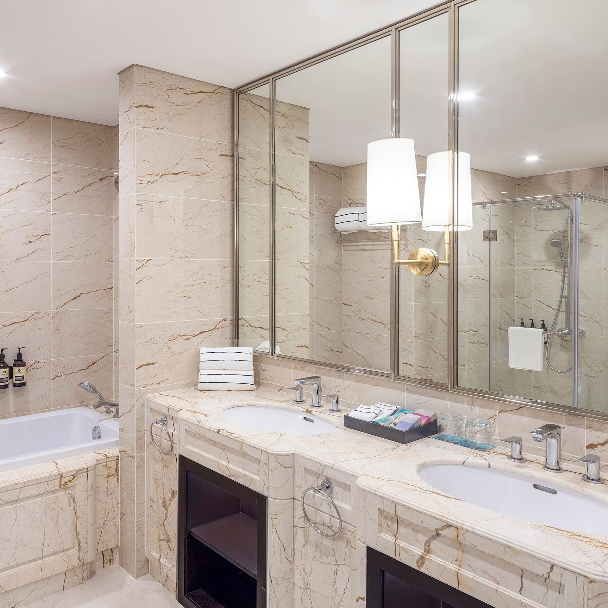 a bathroom with marble countertops and a tub
