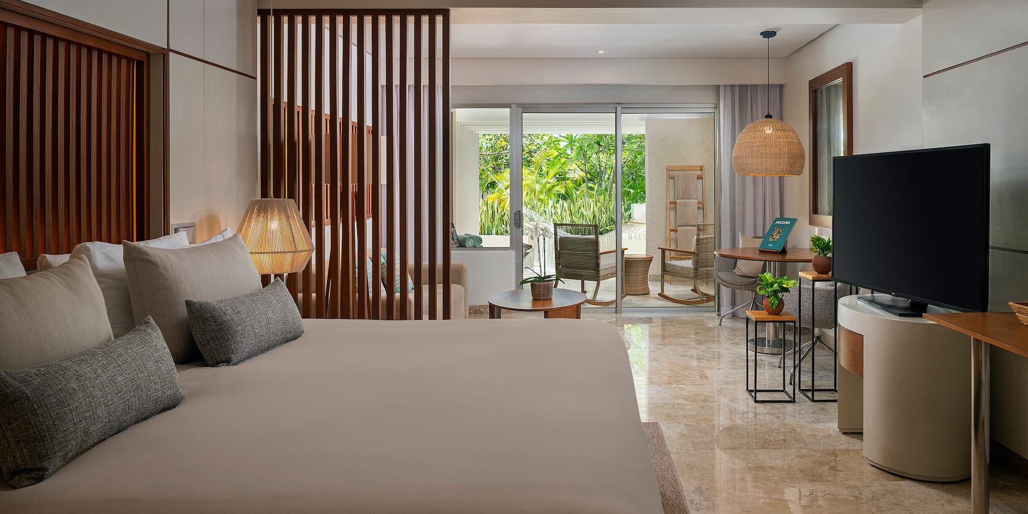 a bedroom with a television and a large bed