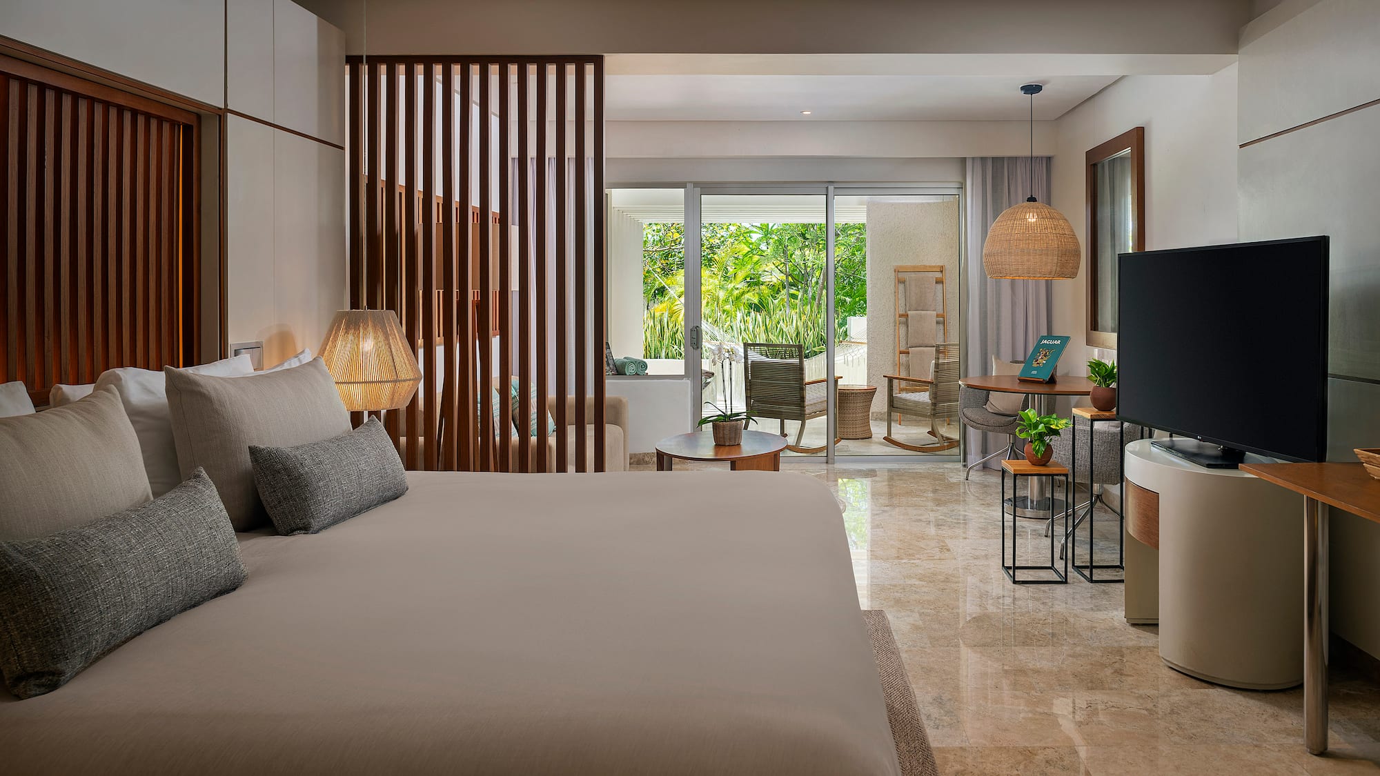 a bedroom with a television and a large bed