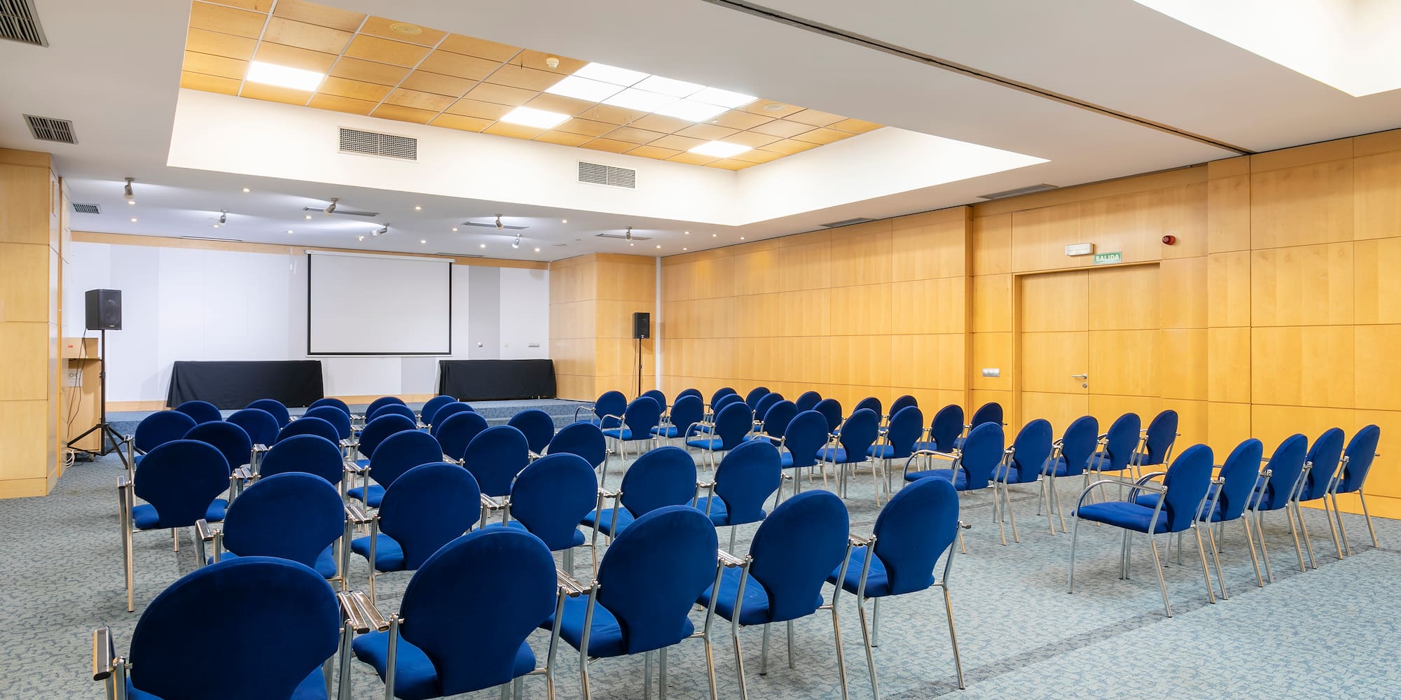 a room with blue chairs and a white board