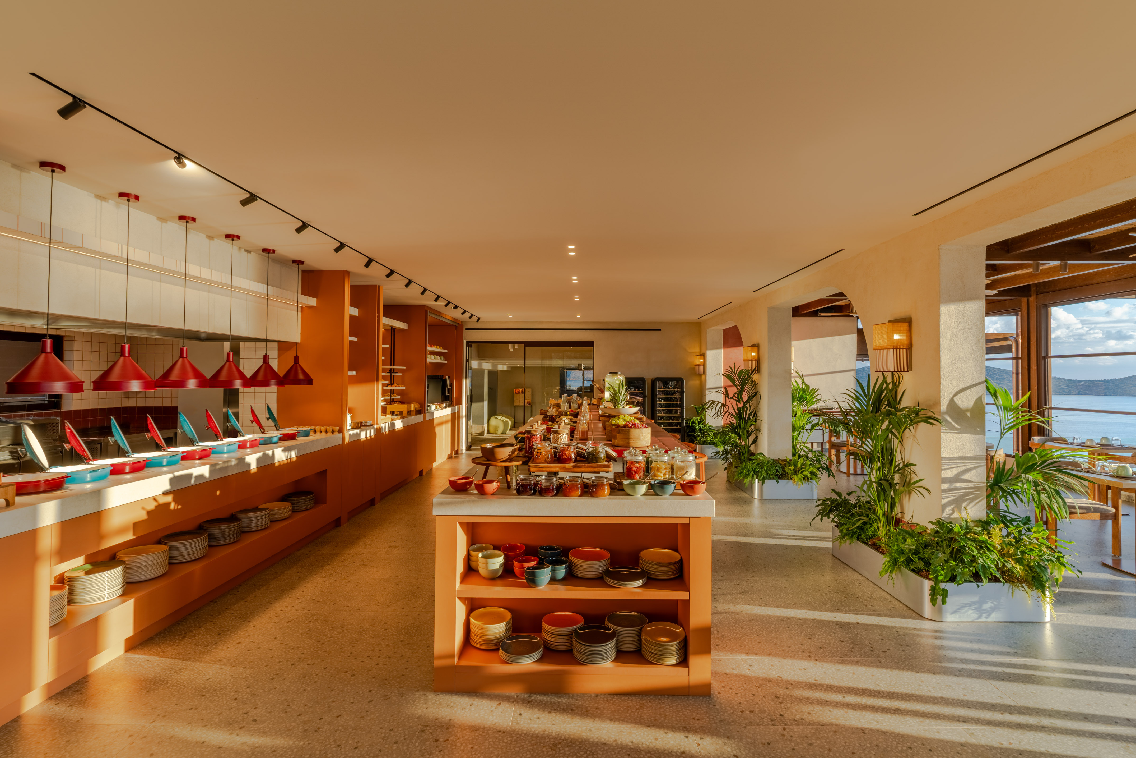Spacious hotel breakfast buffet with diverse food and scenic ocean view.