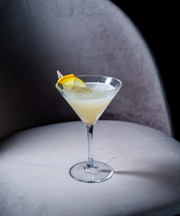 a glass with a lemon wedge in it