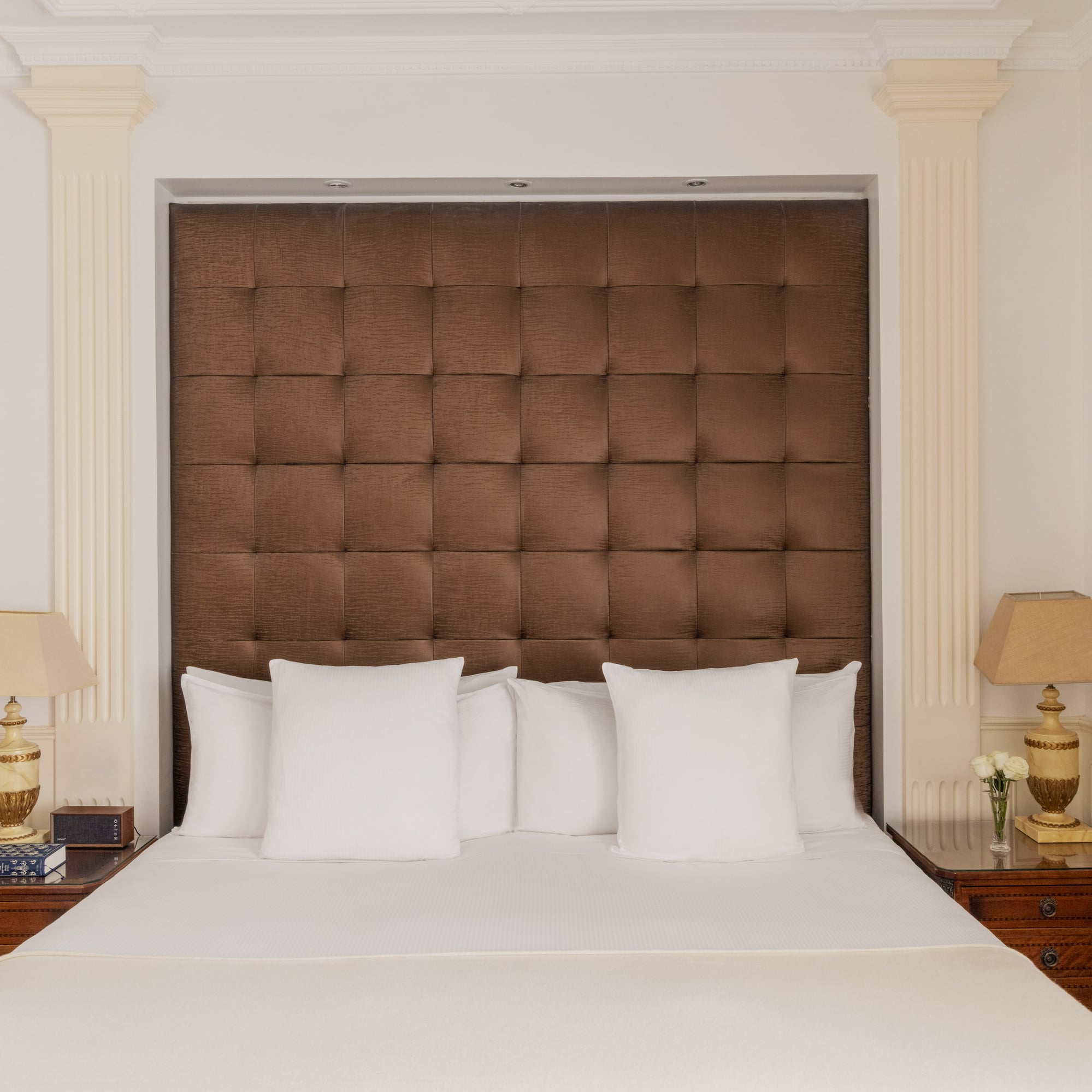 a bed with pillows and lamps in a room