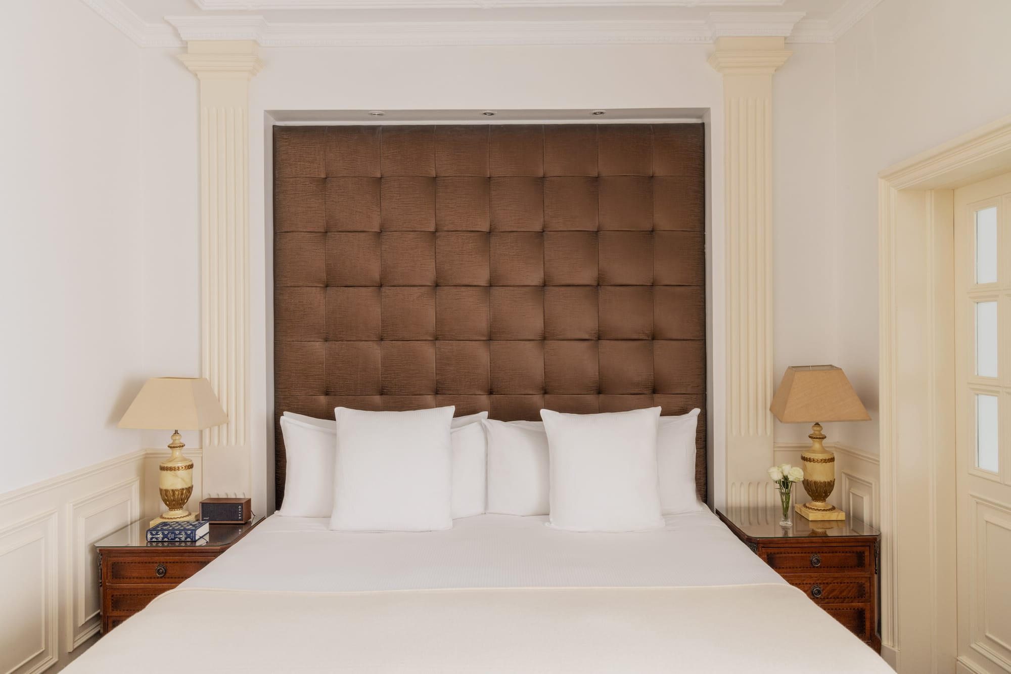 a bed with pillows and lamps in a room