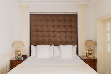 a bed with pillows and lamps in a room