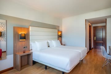 a room with two beds and a wood floor