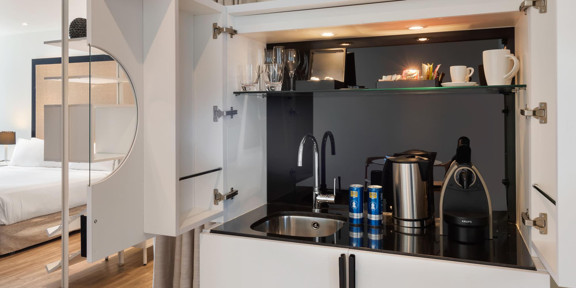 a kitchen with a sink and a mirror