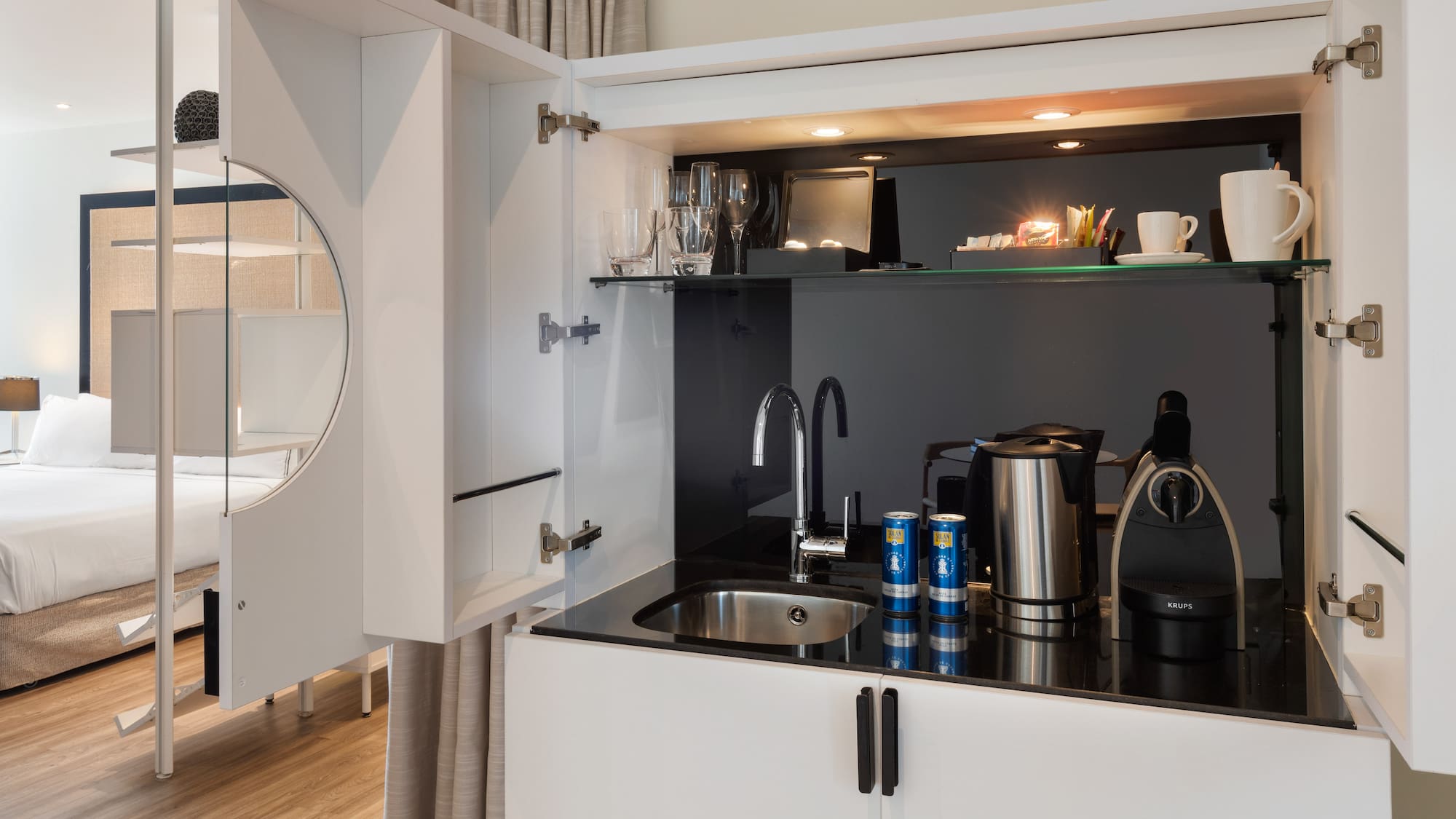 a kitchen with a sink and a mirror