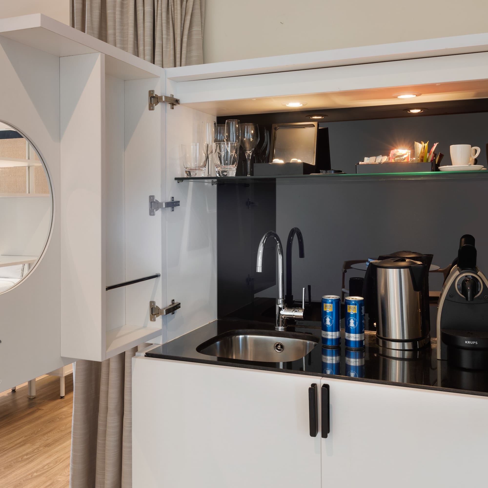 a kitchen with a sink and a mirror