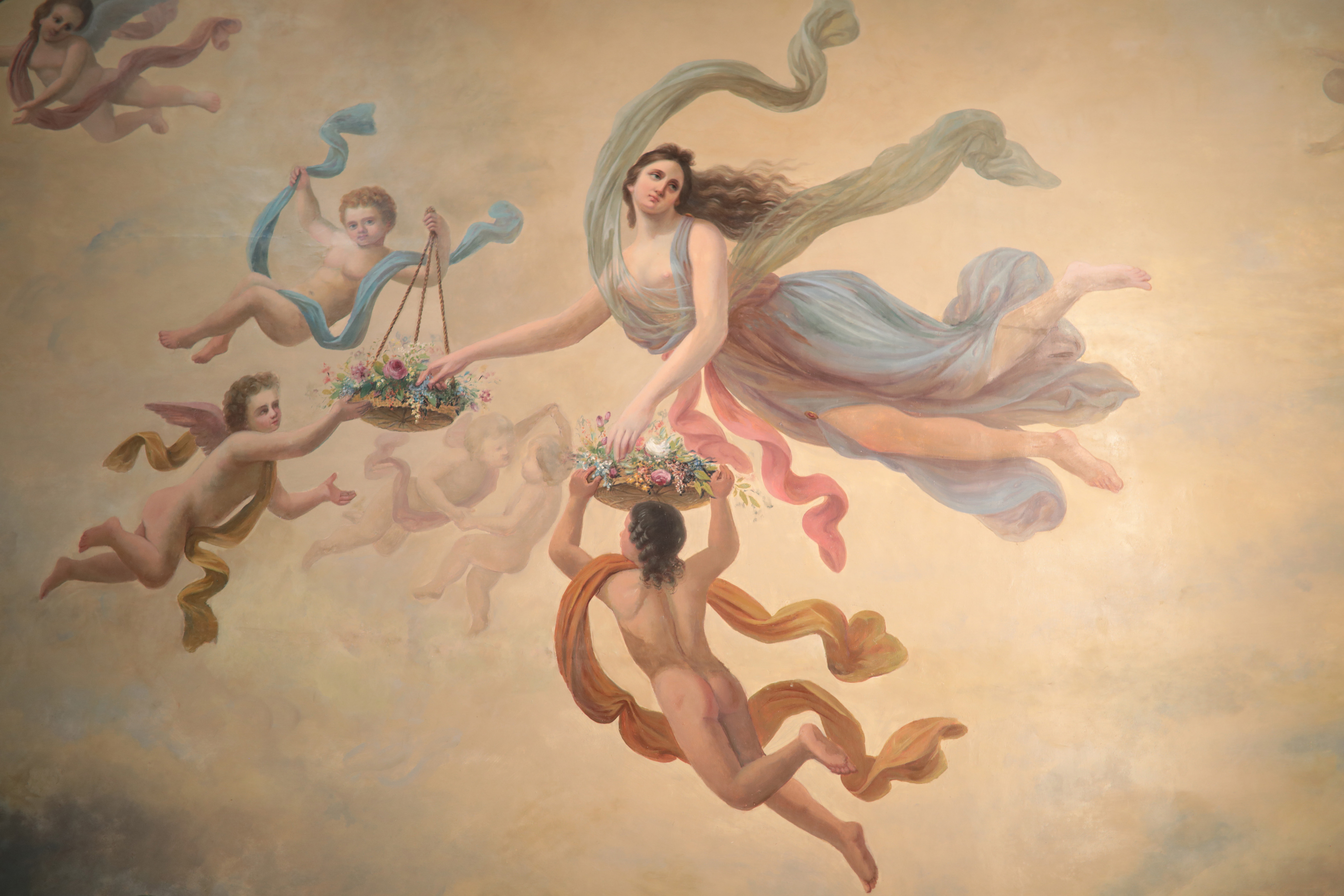 Baroque painting of a goddess and putti with baskets of flowers.