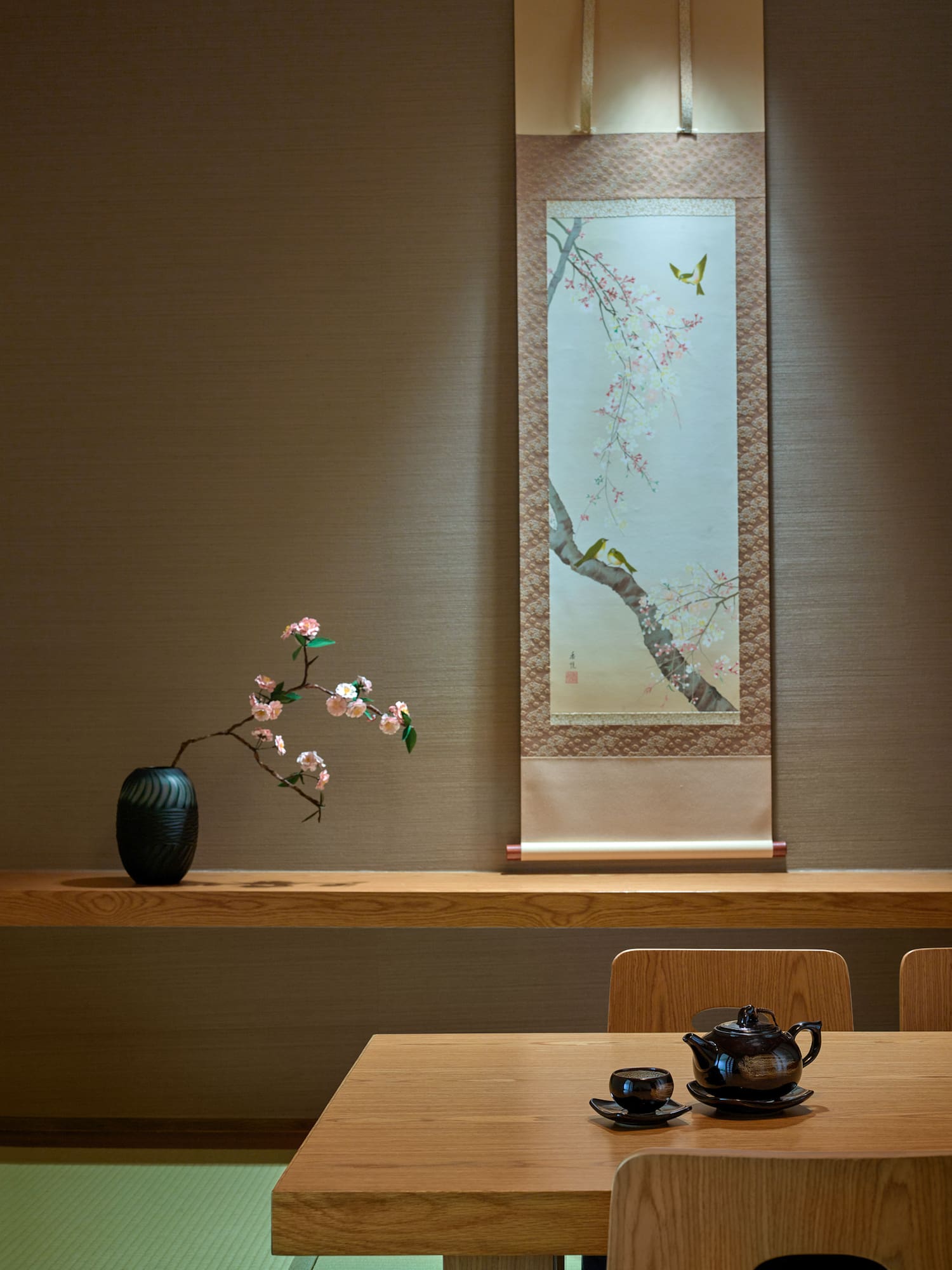 a table with a vase and a teapot on it