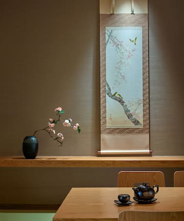 a table with a vase and a teapot on it